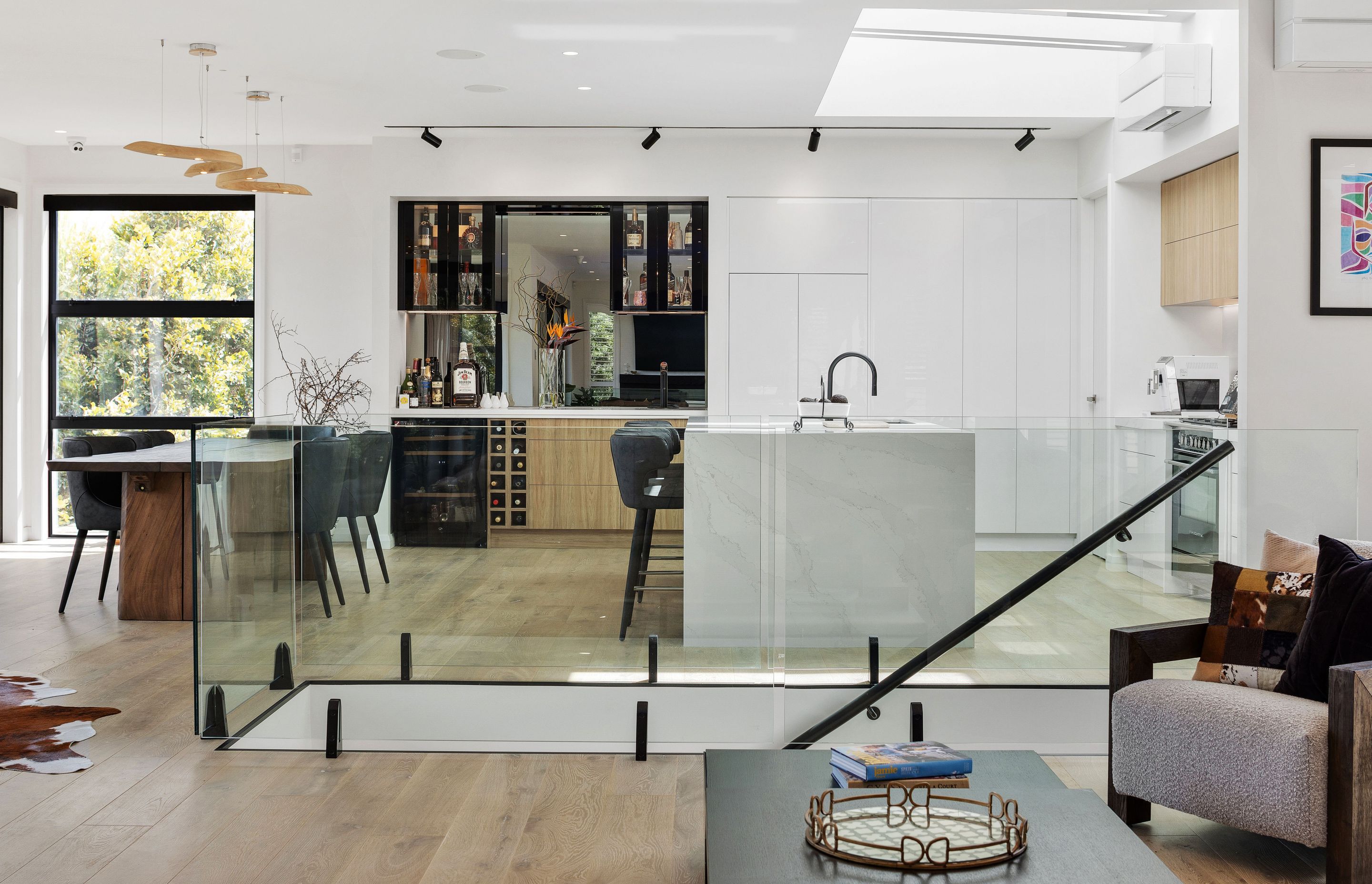 The open-plan kitchen and dining area features a mirrored bar.