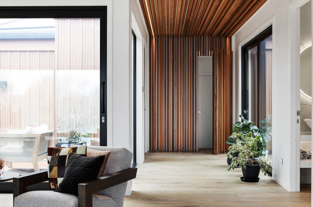 The cedar 'waterfall' artfully conceals the door to the bedrooms.