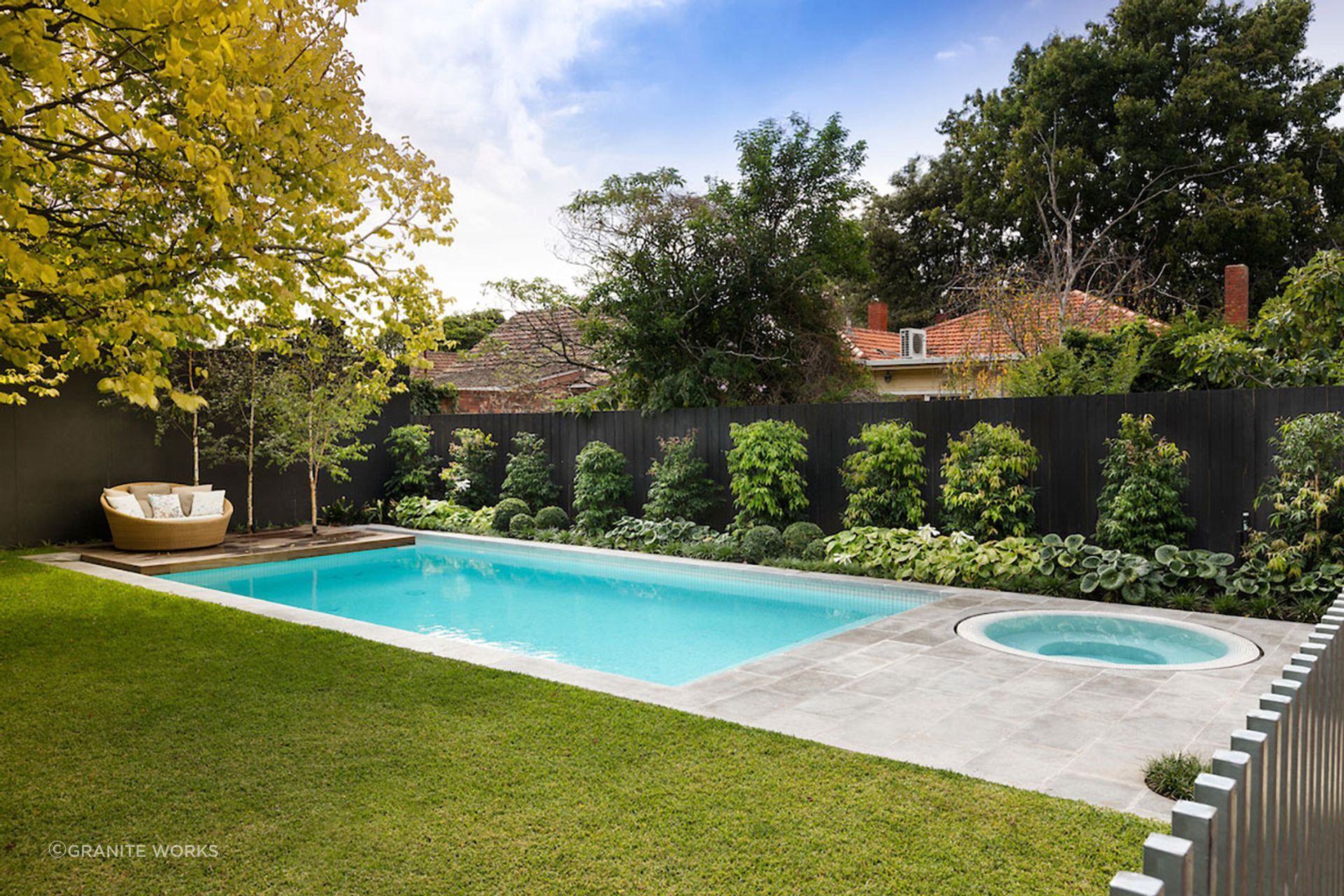 Limestone pavers look excellent around a modern swimming pool.