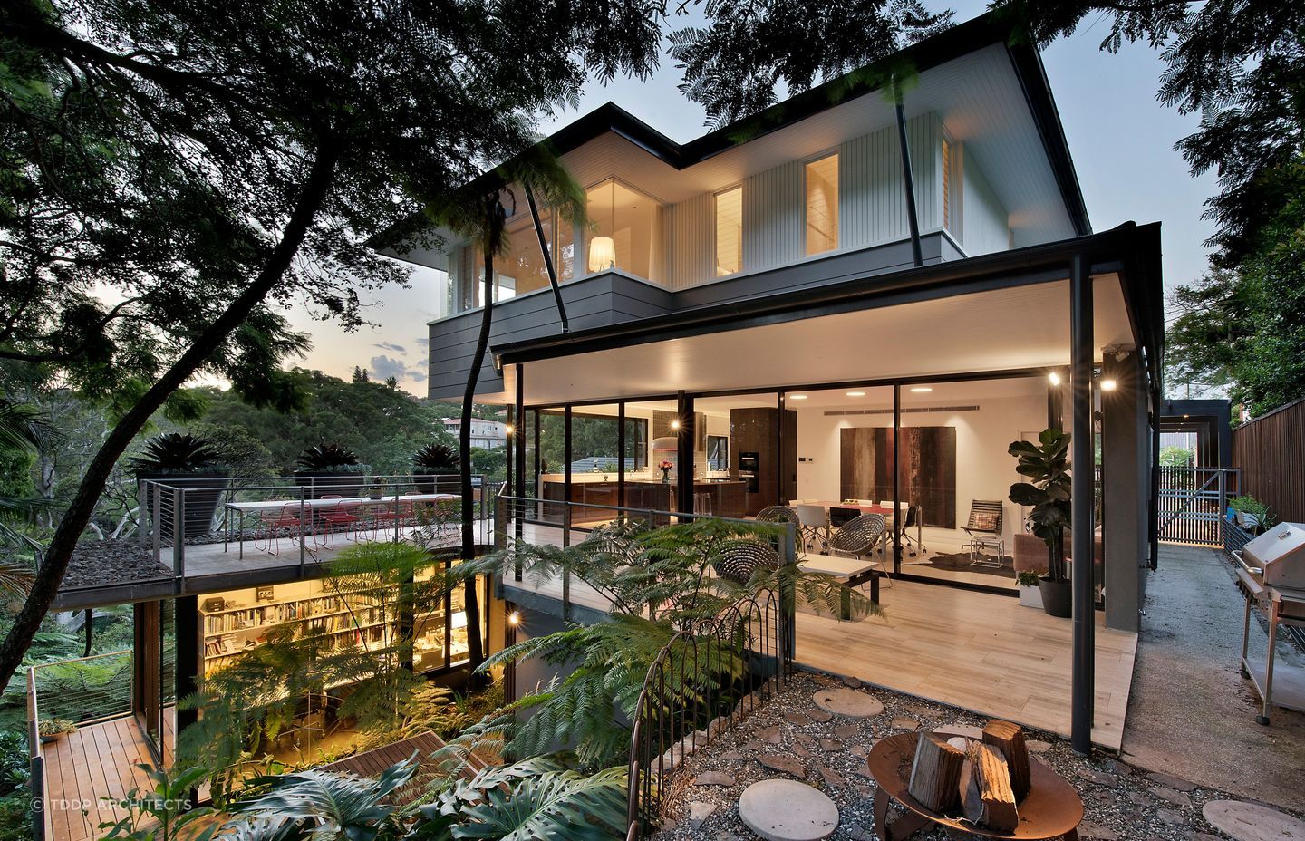 The house is designed to harmonise with the surrounding rainforest vegetation. Photography: Adam Resch