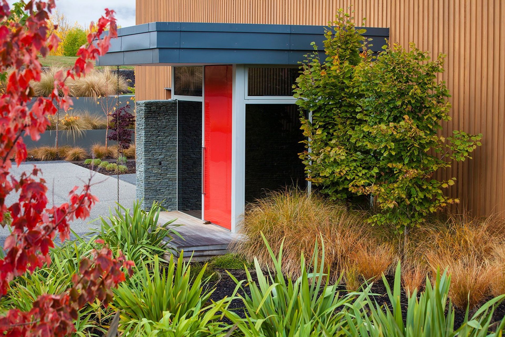 The vibrancy of Resene Trubridge Red was the perfect addition to this contemporary home, which has been finished in Resene Hartwood natural wood stain..