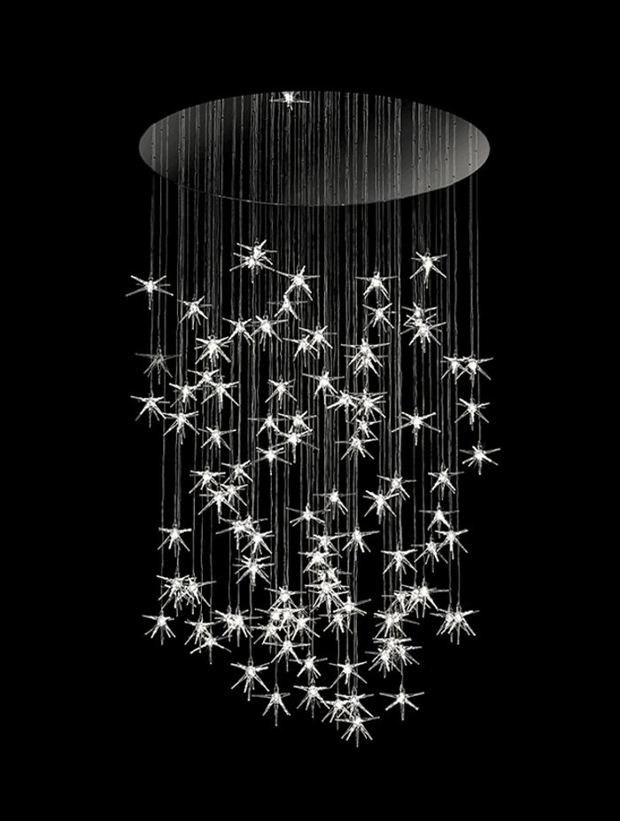 Stella Chandelier with pendant stars in blown borosilicate glass. Composition, quantity and length are customisable