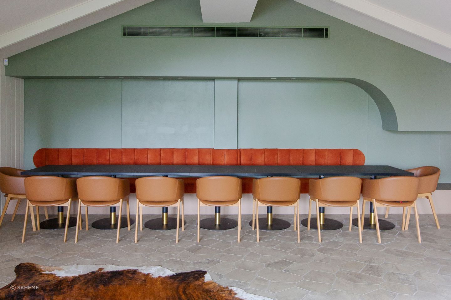 A spacious dining room featuring large-format floor tiles designed with fewer grout lines, creating a seamless and visually expansive surface