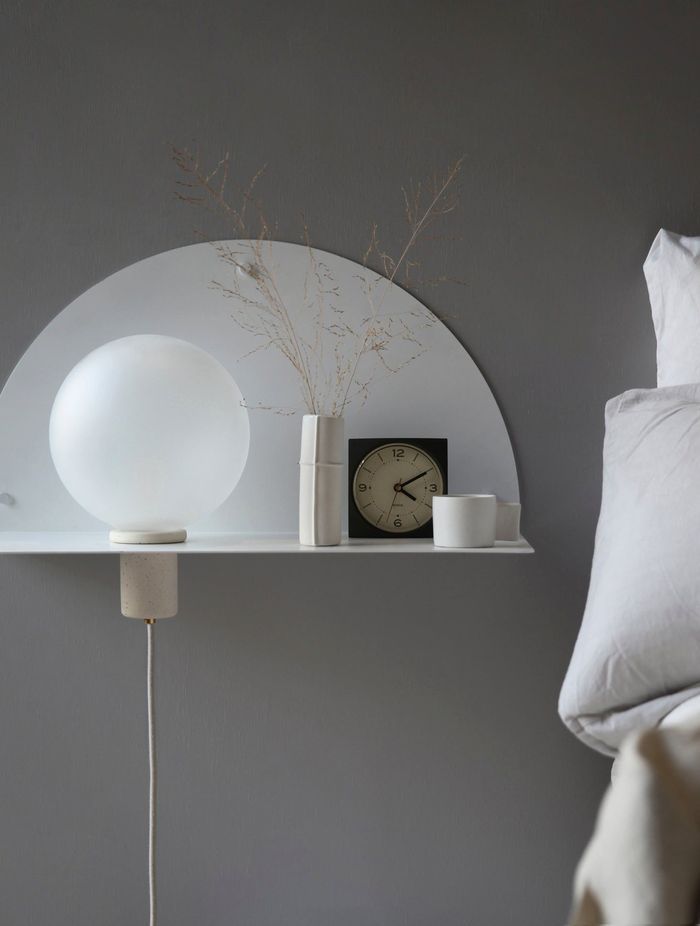 A wall-mounted bedside table maximises floor space, while complimenting a bedroom's interior design. Featured product: Lune Wall Shelf.