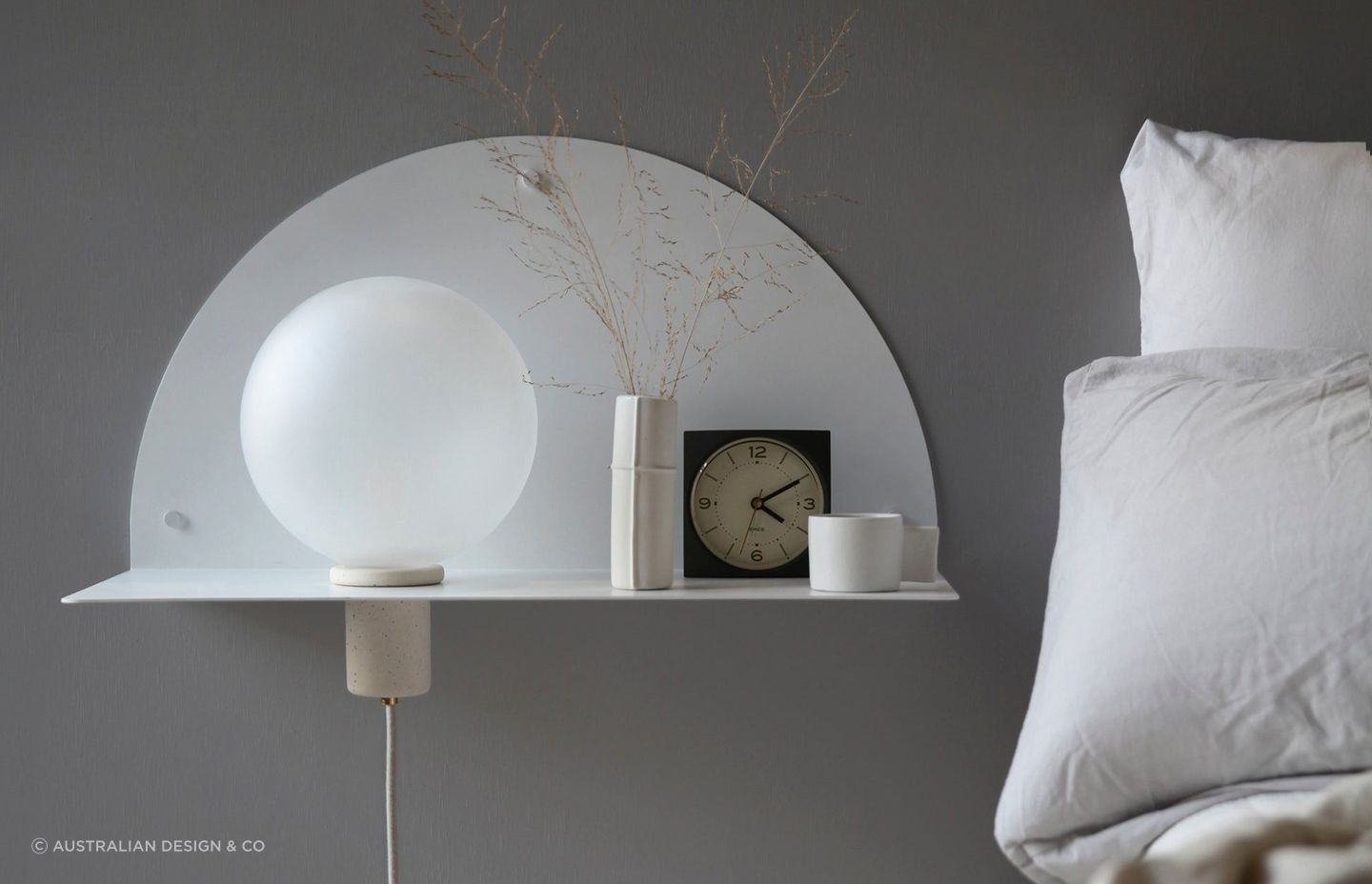 A wall-mounted bedside table maximises floor space, while complimenting a bedroom's interior design. Featured product: Lune Wall Shelf.