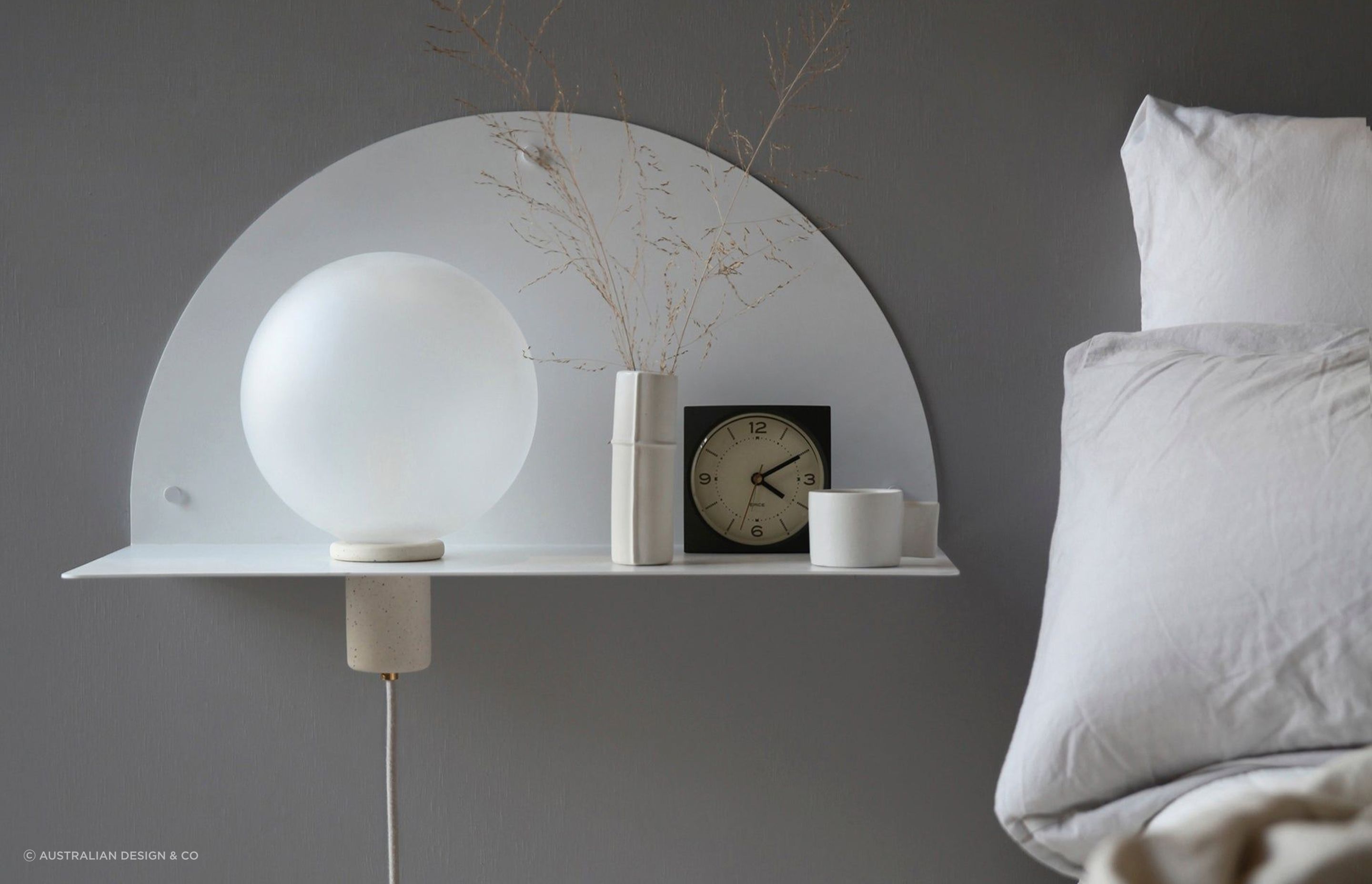 A wall-mounted bedside table maximises floor space, while complimenting a bedroom's interior design. Featured product: Lune Wall Shelf.