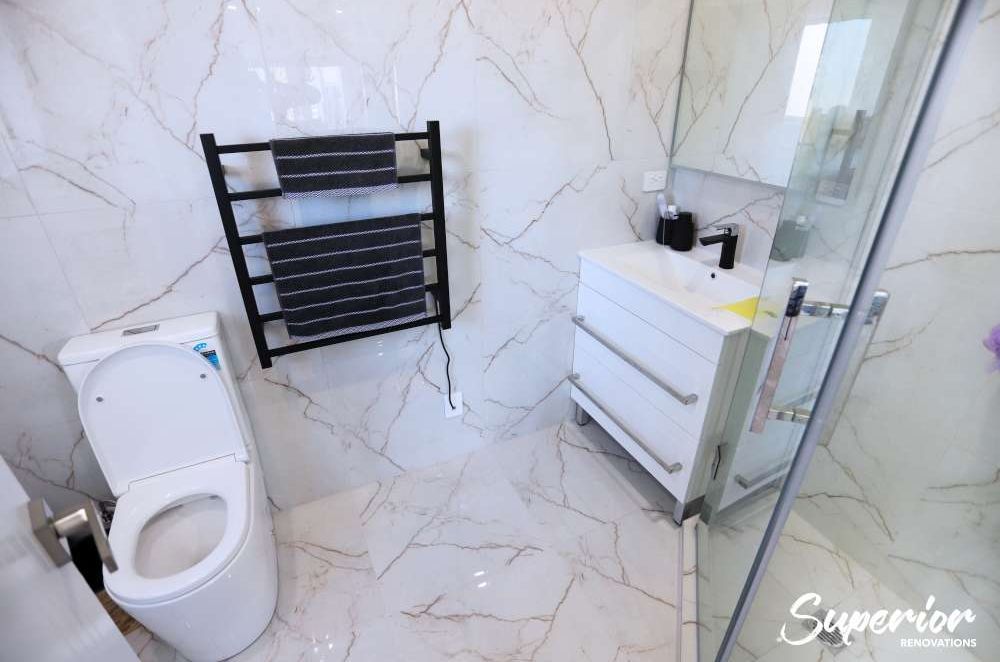 This was a very small awkward place but our clients wanted to make this a guest ensuite. We used the corner L shaped area to make a tiled glass door shower. The same times were used on the walls and floors to give an illusion of space – Bathroom renovatio