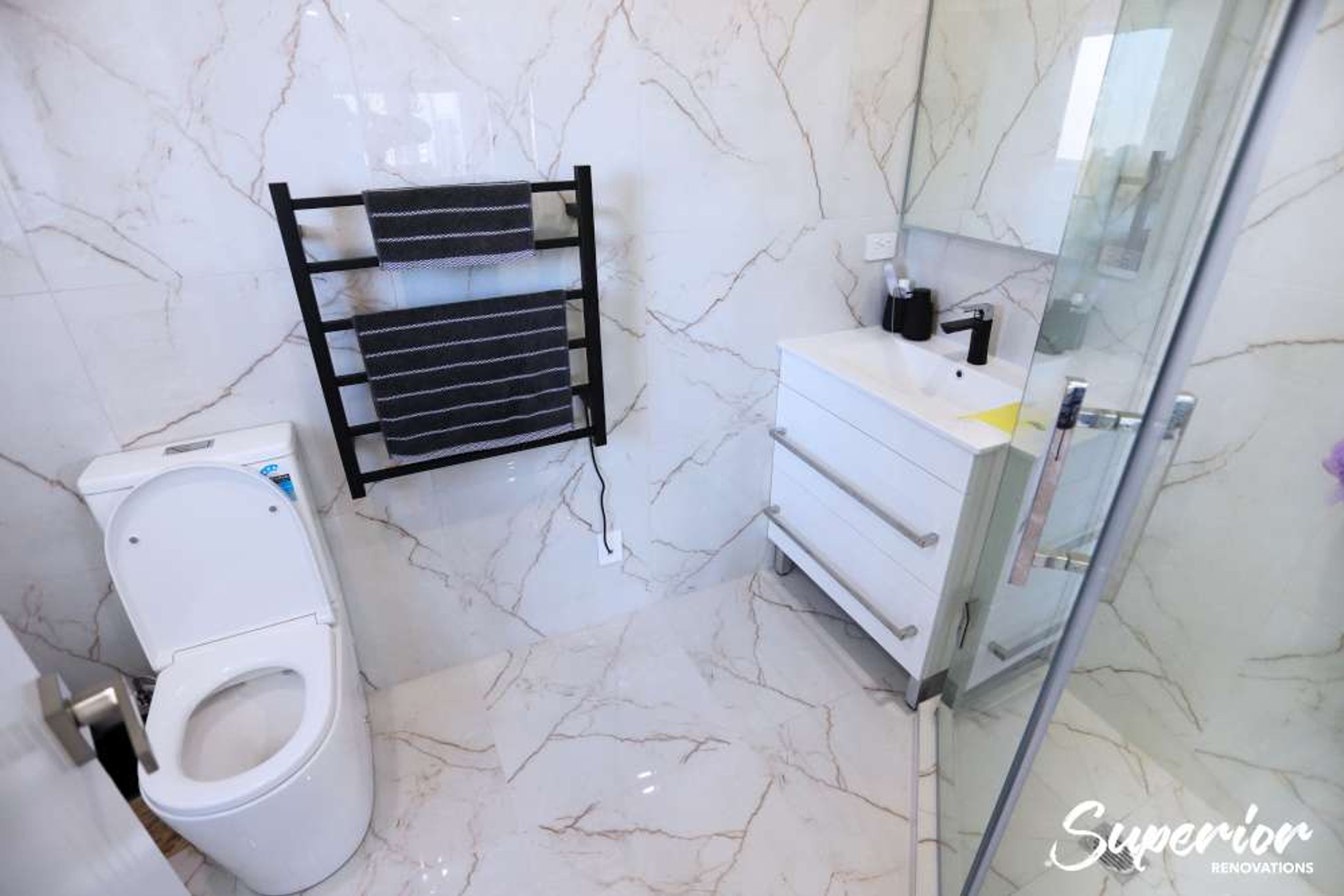 This was a very small awkward place but our clients wanted to make this a guest ensuite. We used the corner L shaped area to make a tiled glass door shower. The same times were used on the walls and floors to give an illusion of space – Bathroom renovatio