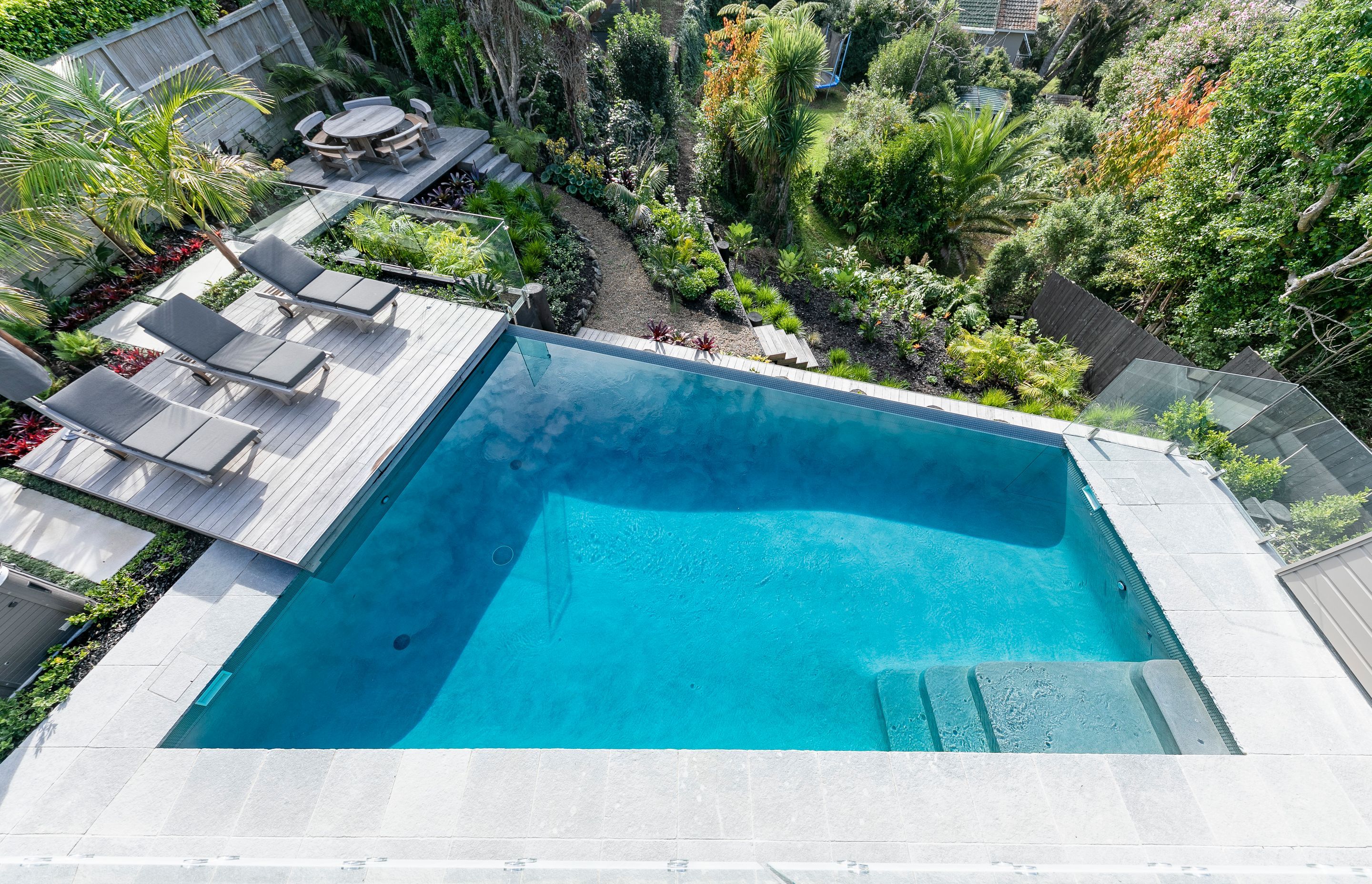 The swimming pool, constructed by Auckland Inground Pools, was the centrepiece of the landscaping project.