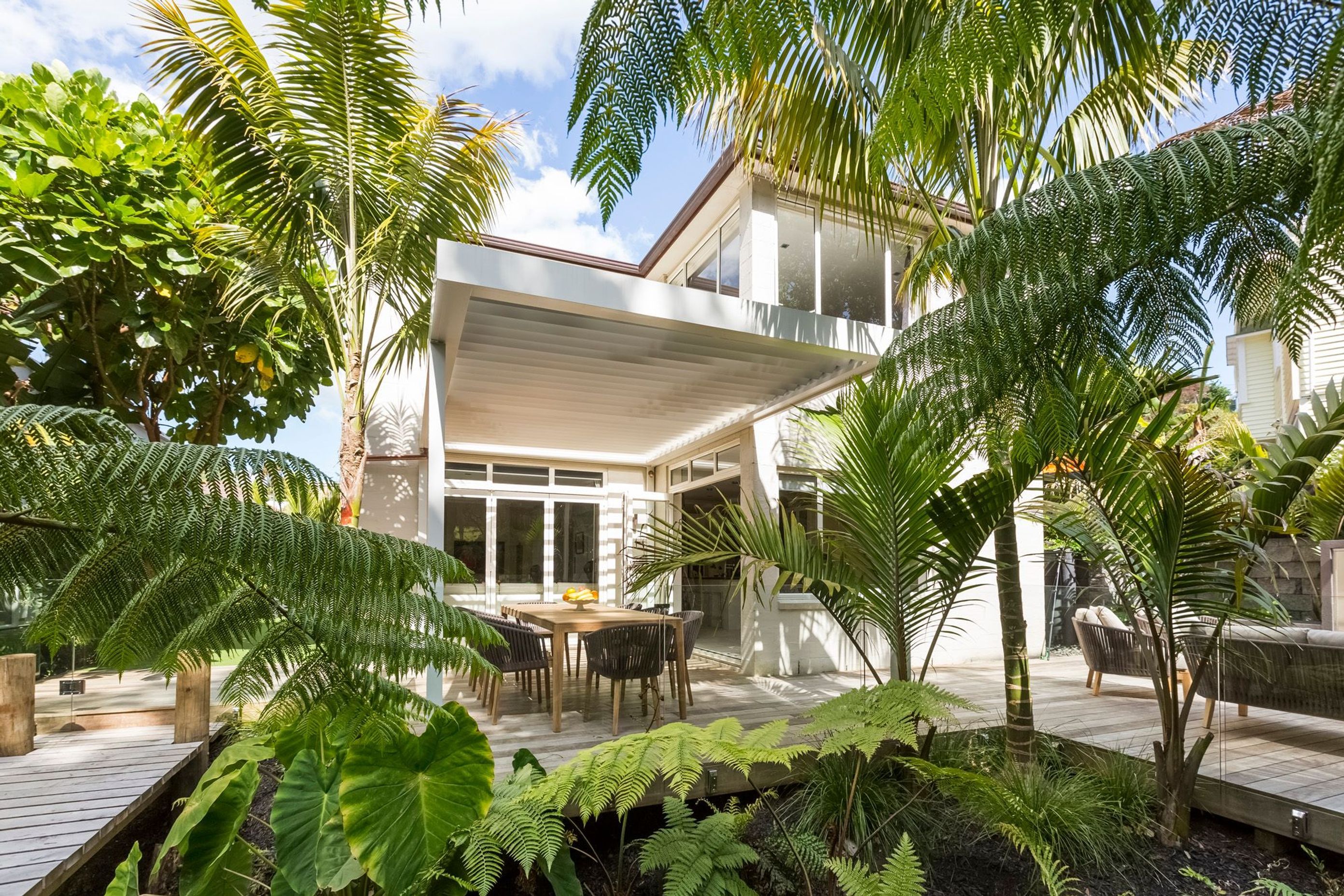 A fernery surrounded by a timber walkway is a great way to break up a back yard into a distinctive outdoor room, as well as being low maintenance and creating the effect of being situated within a lush forest.