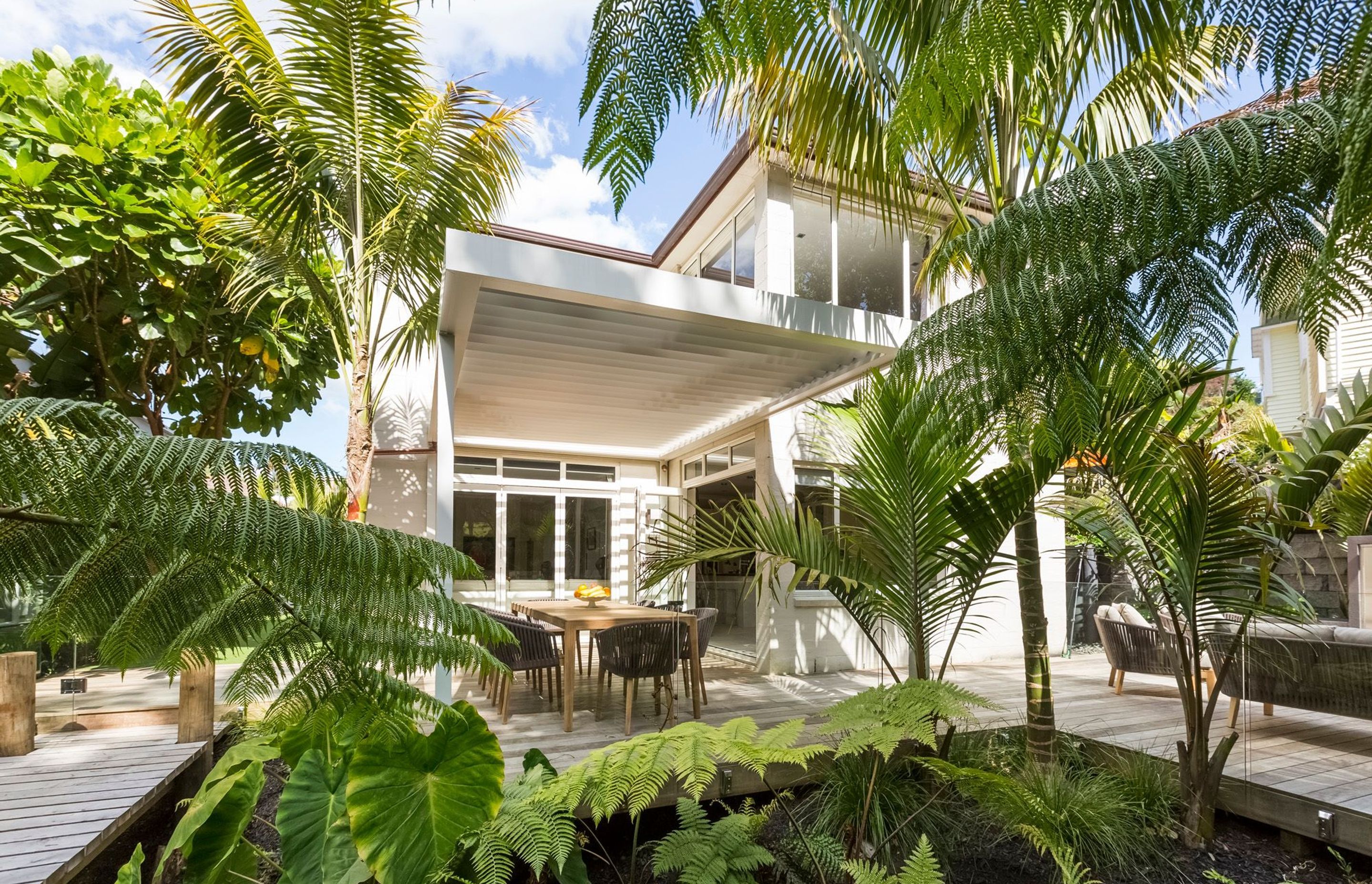 A fernery surrounded by a timber walkway is a great way to break up a back yard into a distinctive outdoor room, as well as being low maintenance and creating the effect of being situated within a lush forest.