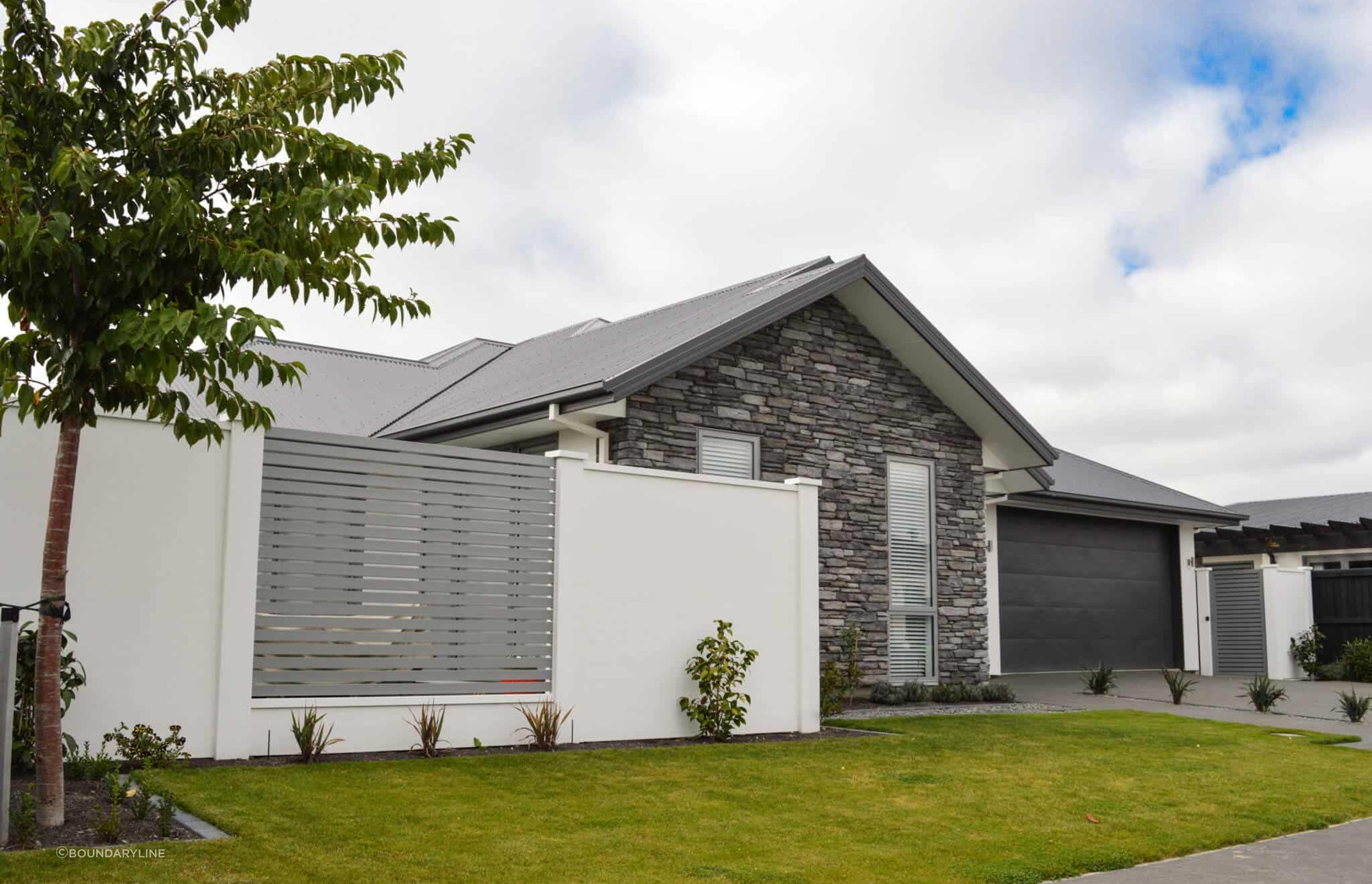 Composite Fencing can be an affordable long-term solution, shown here with Elite Wall by Boundaryline.