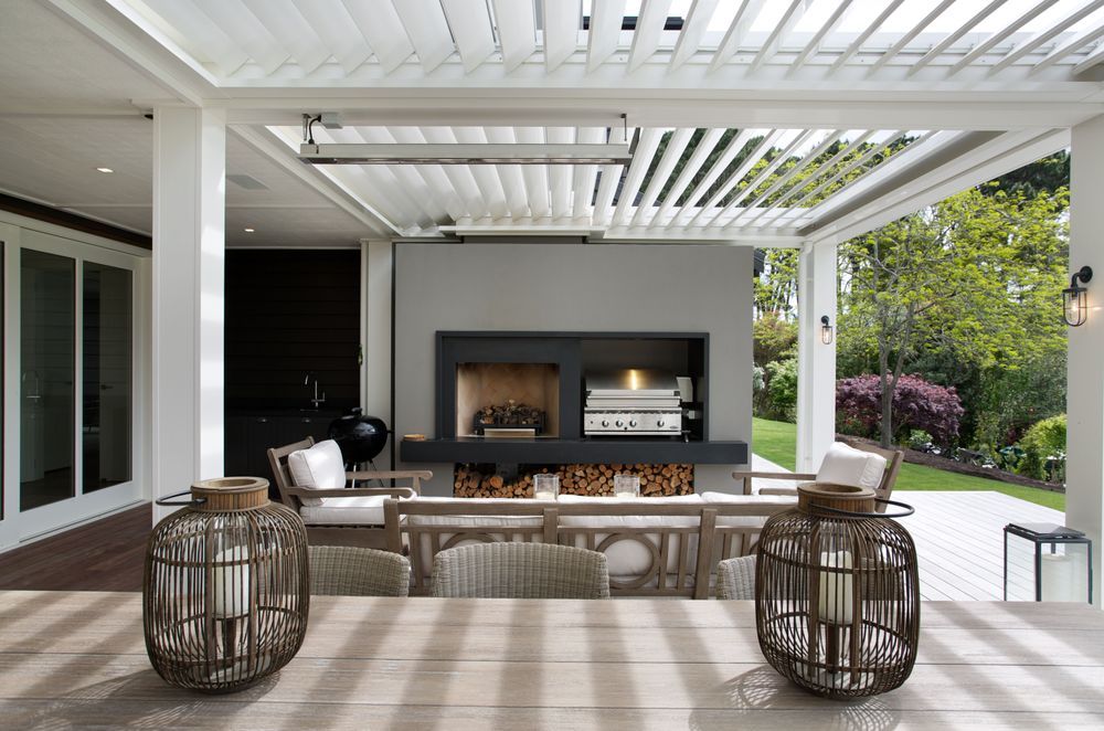 Trendy outdoor kitchen unit with additional décor truly raises the bar, courtesy of BJ — The Craft of Custom Cabinetry.
