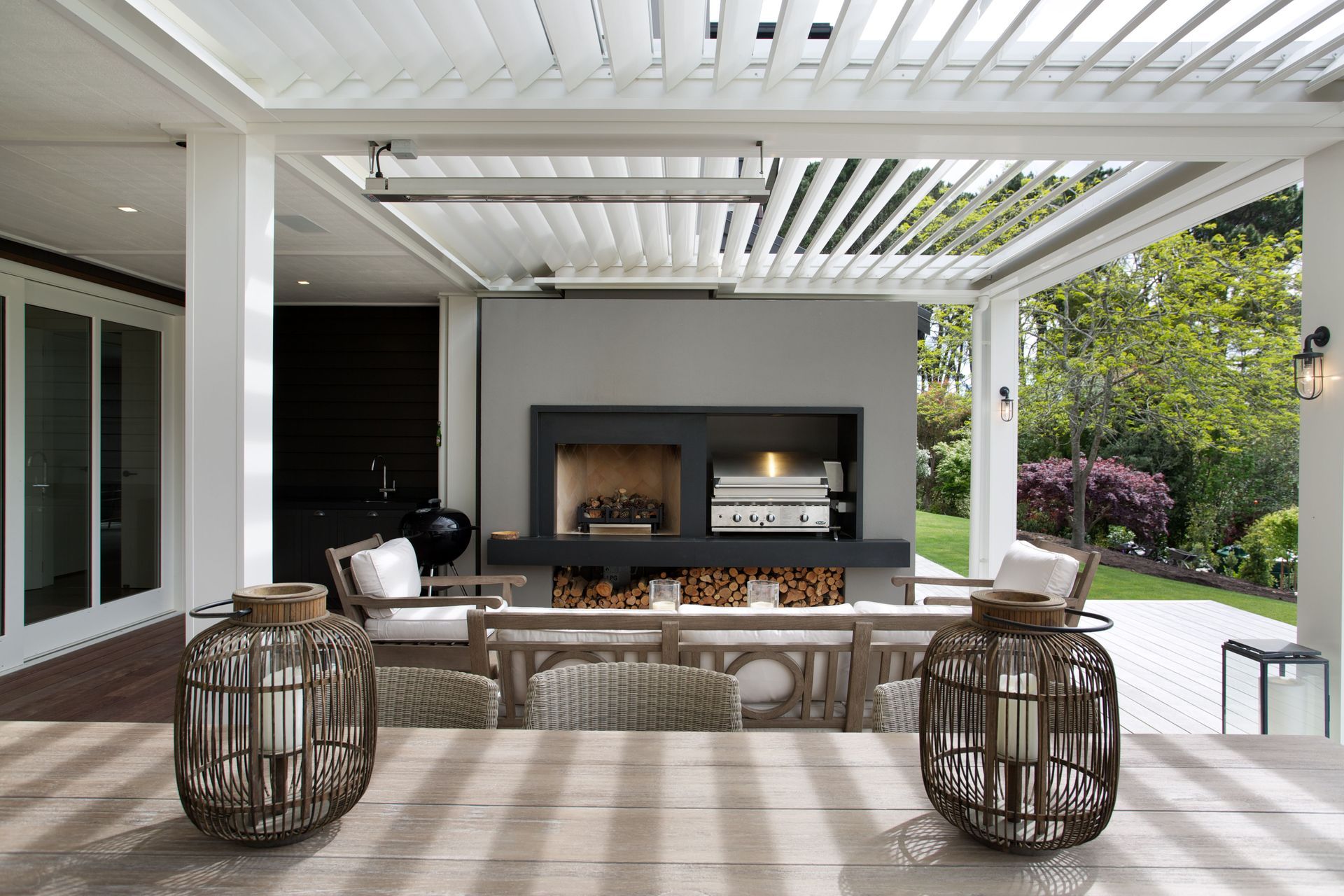 Trendy outdoor kitchen unit with additional décor truly raises the bar, courtesy of BJ — The Craft of Custom Cabinetry.