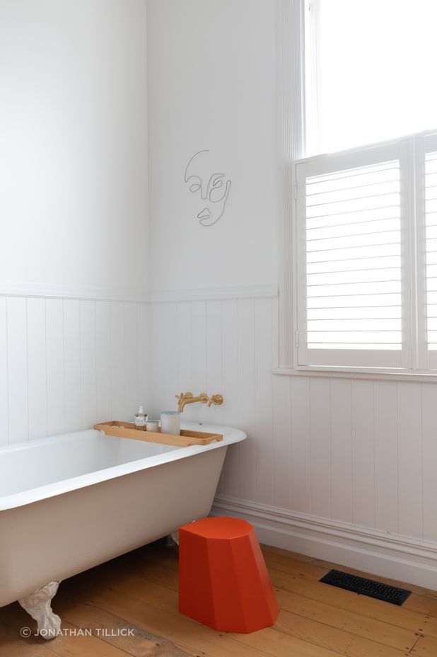 An Arnoldino stool in orange adds a pop of colour.