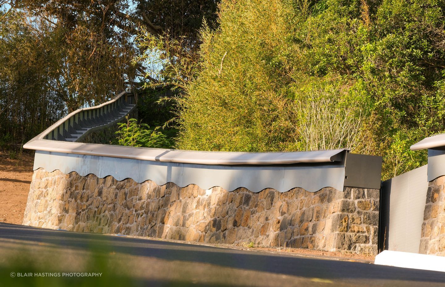The stone wall and its detailing has been made to blend with the existing boundary wall and other older stone structures within the zoo.