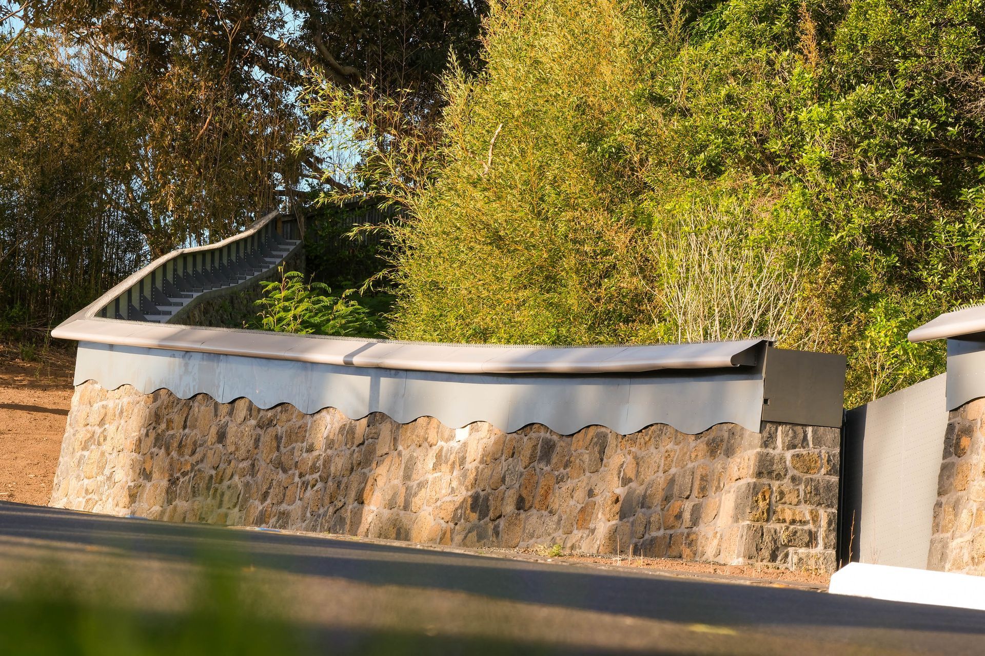 The stone wall and its detailing has been made to blend with the existing boundary wall and other older stone structures within the zoo.