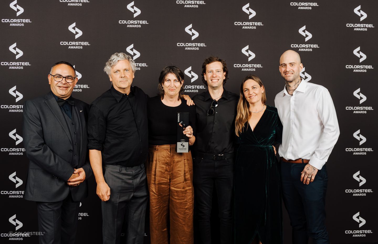 Kerr Ritchie Architects accepts the award for Residential Building of the Year with the Velvin Building team.