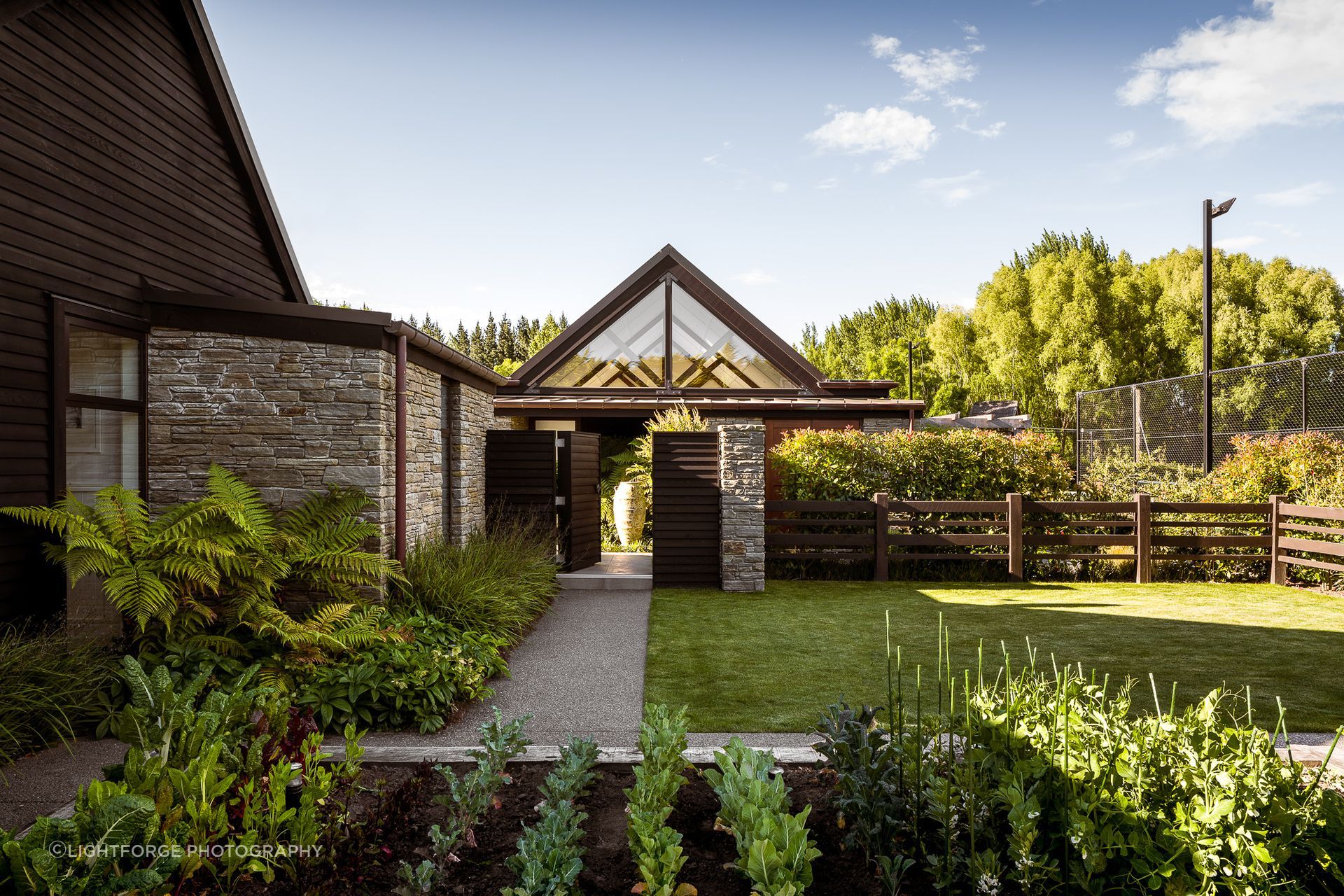 This private, safe, family-oriented garden was designed for a family of six by Kamo Marsh Queenstown, with space for children to play and guests to be entertained year round.