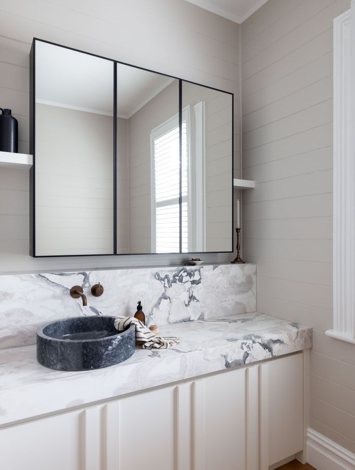 The original shiplap has been retained in the bathroom to honour the home's heritage.