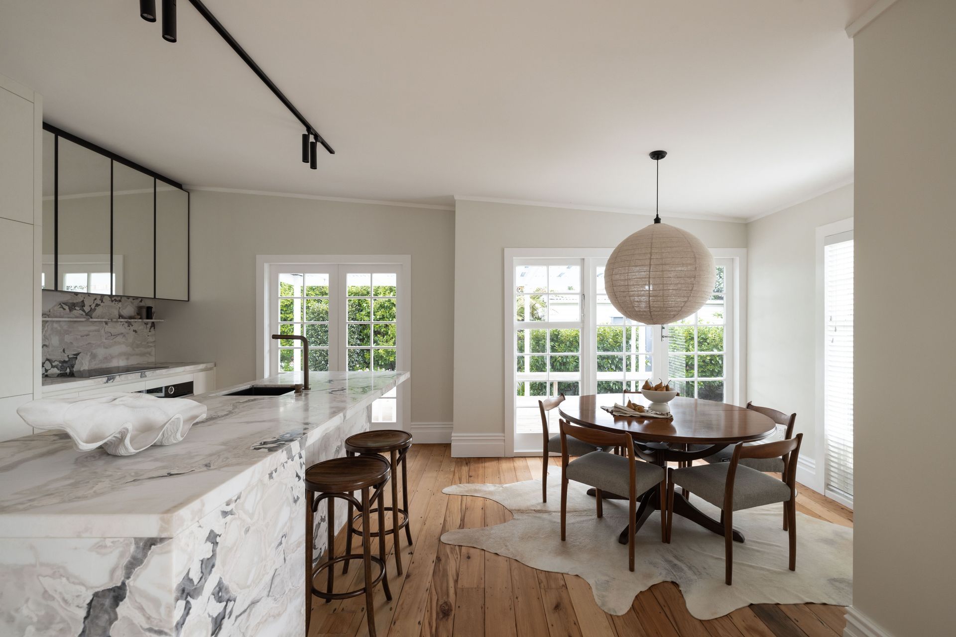A natural linen pendant light from Corcovado is suspended over the dining table.
