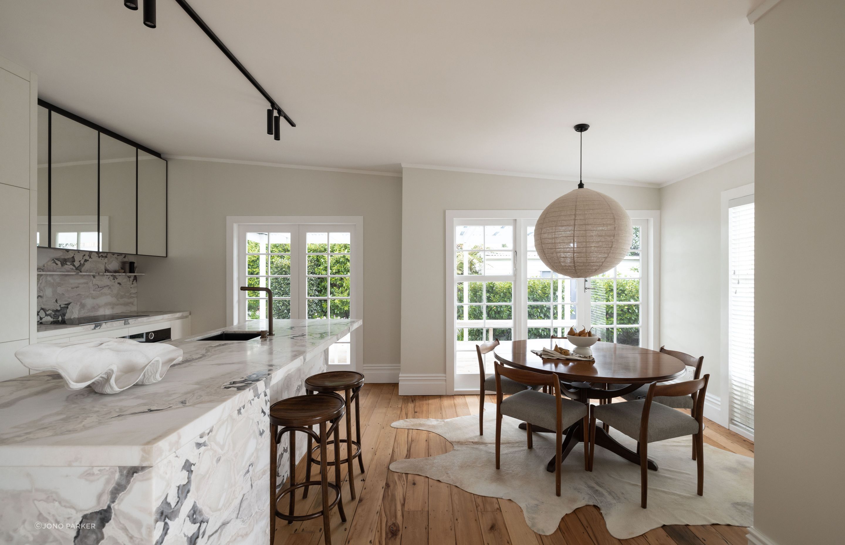 A natural linen pendant light from Corcovado is suspended over the dining table.