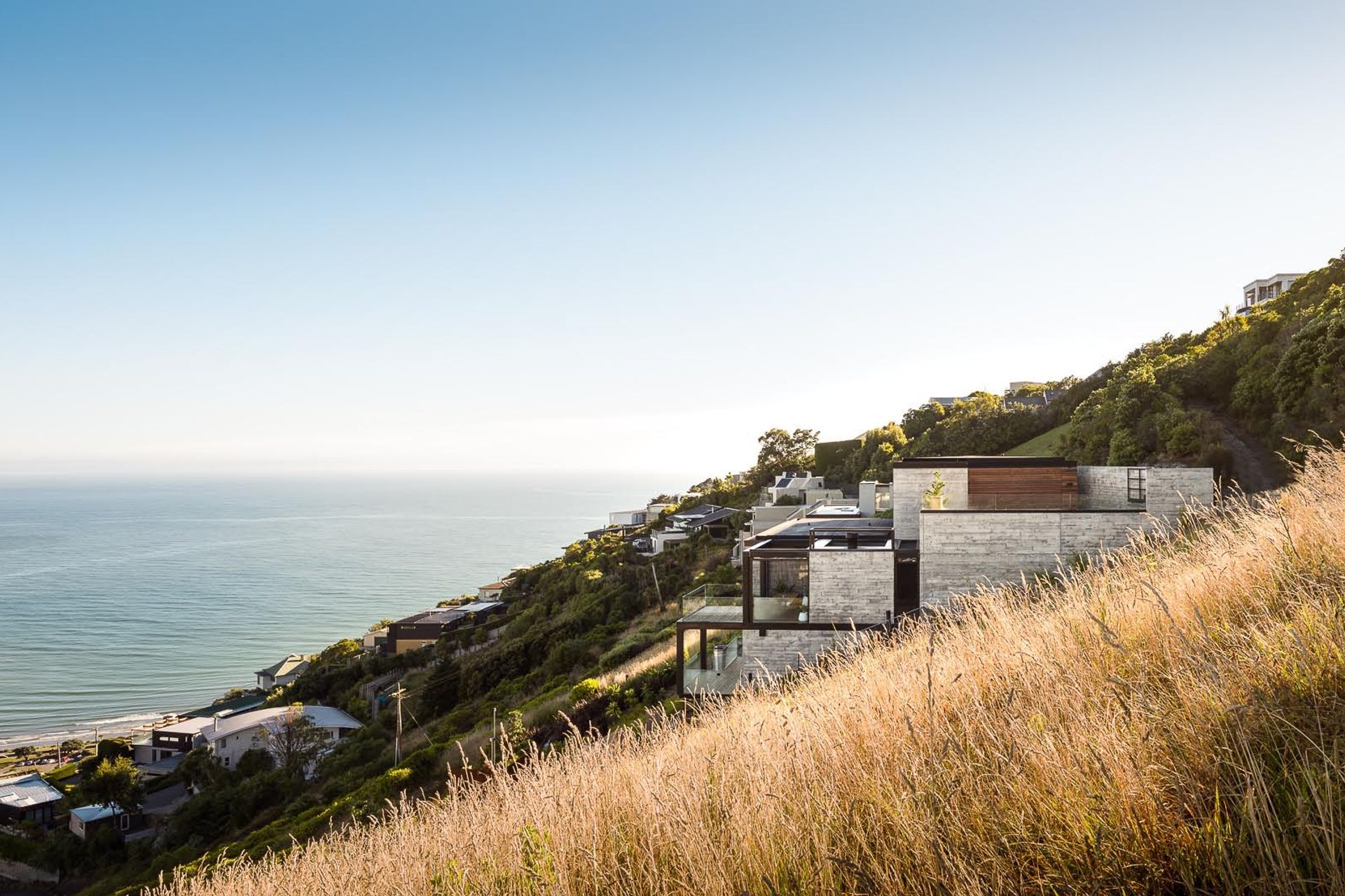 "Photographers have their unique styles, and it should be a gut decision whether a given style clicks with a client," says Dennis | Scarborough Béton Brut, Christchurch | Design by Young Architects