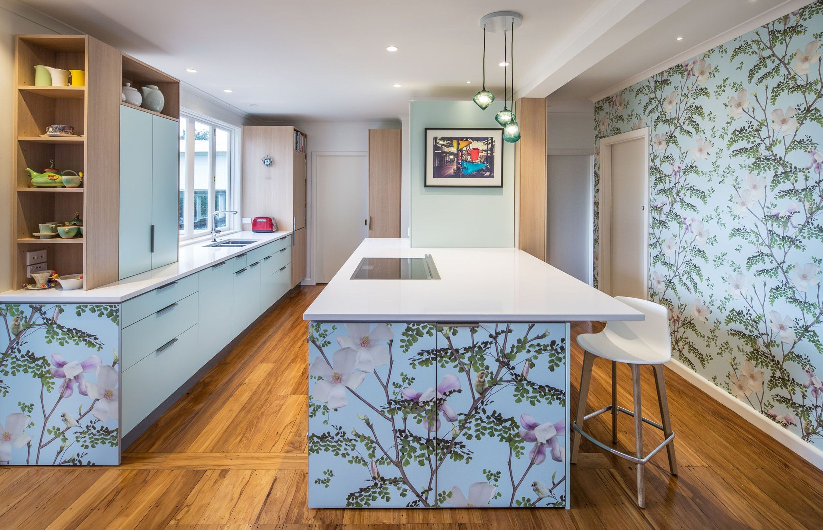 "The Magnolia Kitchen design was built around the client’s love of a magnolia wall mural."