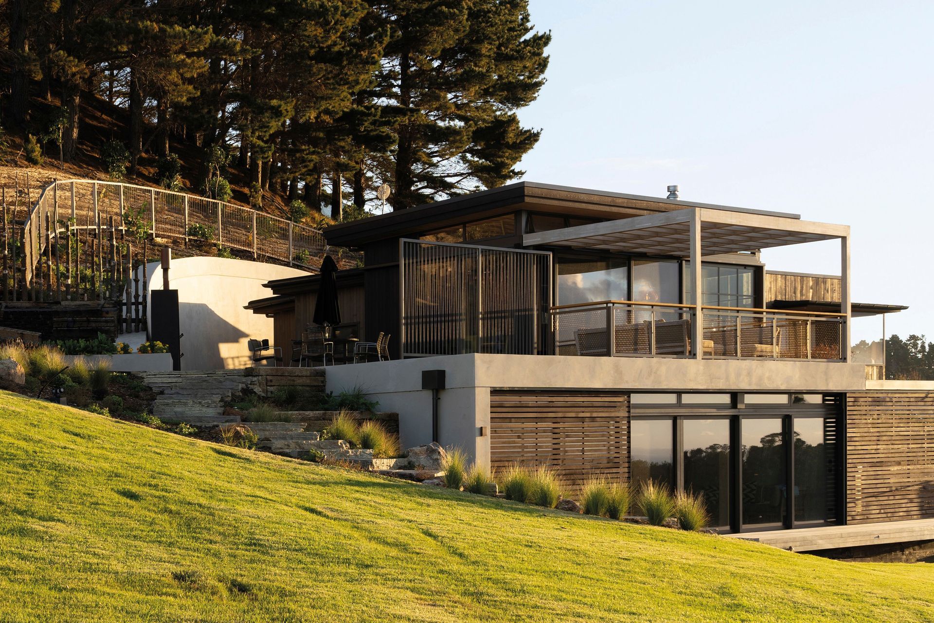 The Onetapu home emerges from the landscape, almost as though it were part of the land itself.