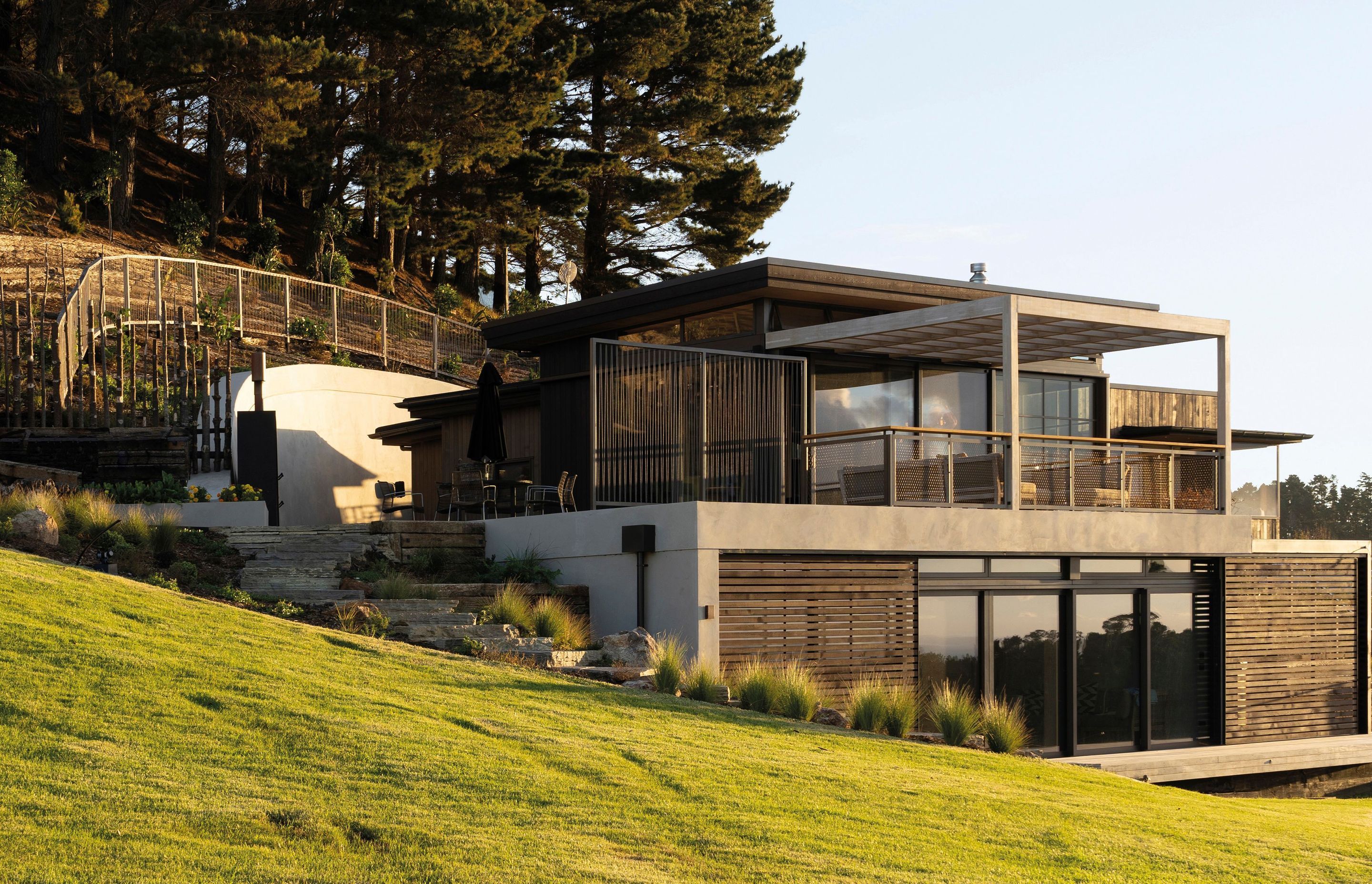 The Onetapu home emerges from the landscape, almost as though it were part of the land itself.