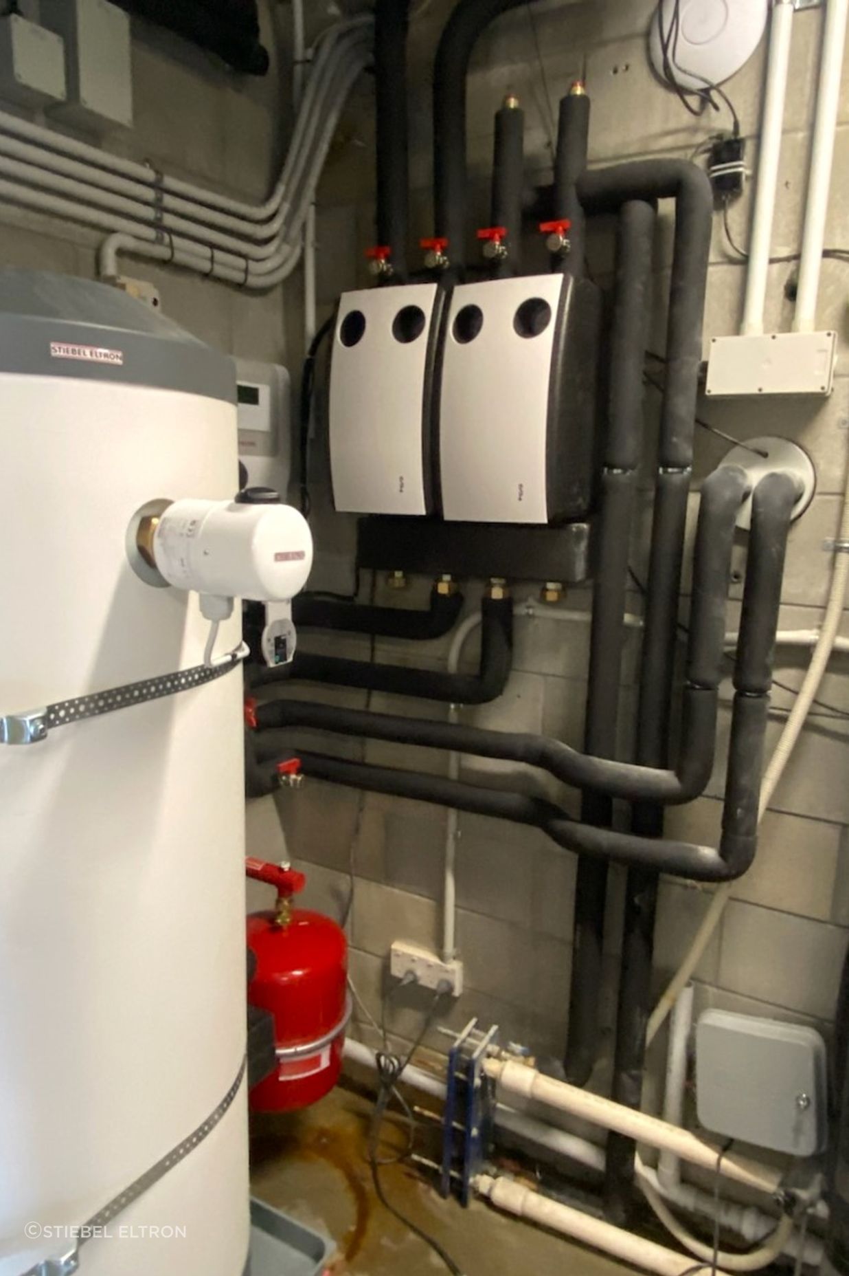 The new plant room set-up replacing the gas boiler with a heating circuit pump station and potable water cylinder.
