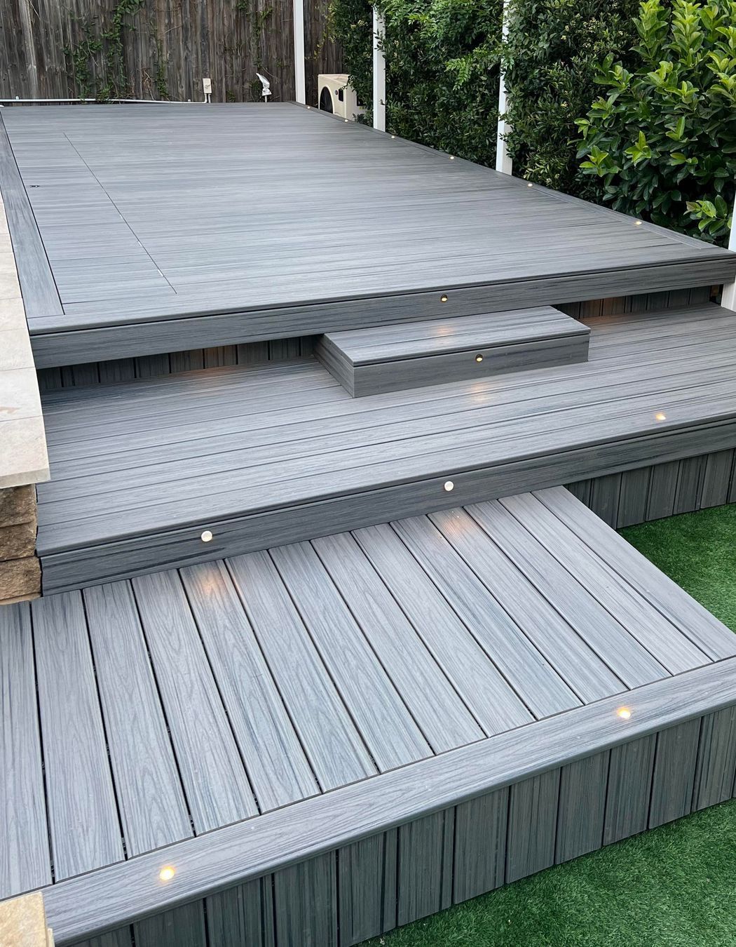 This composite timber deck shows the timber in-laid into the pool cover so that it's virtually invisible.