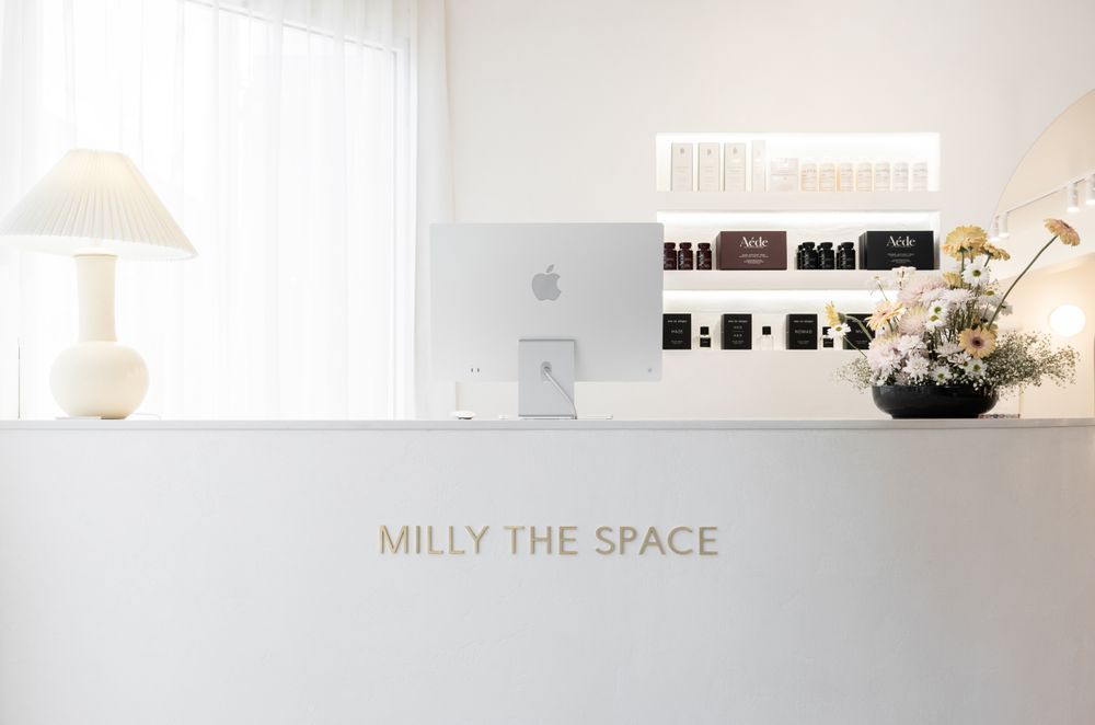 Elegant lettering used on the reception desk at hairdressing salon Milly The Space in a brushed brass finish.