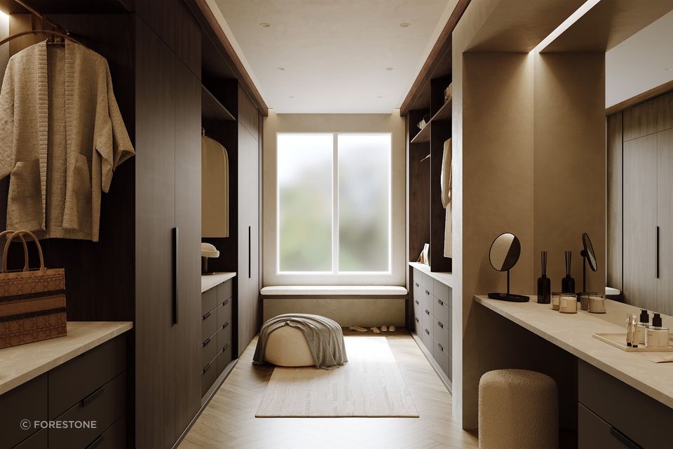 A sophisticated walk-in wardrobe showcasing DesignerOne’s warm, subtle tumber aesthetics and smooth neutral cabinetry for a seamless, contemporary interior.