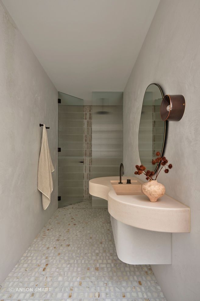 Expella's Shadowline Diffuser Pro creates a near invisible exhaust grille in these bathrooms at Nomad House (left) and Pacific House (right) by Alexander &CO.