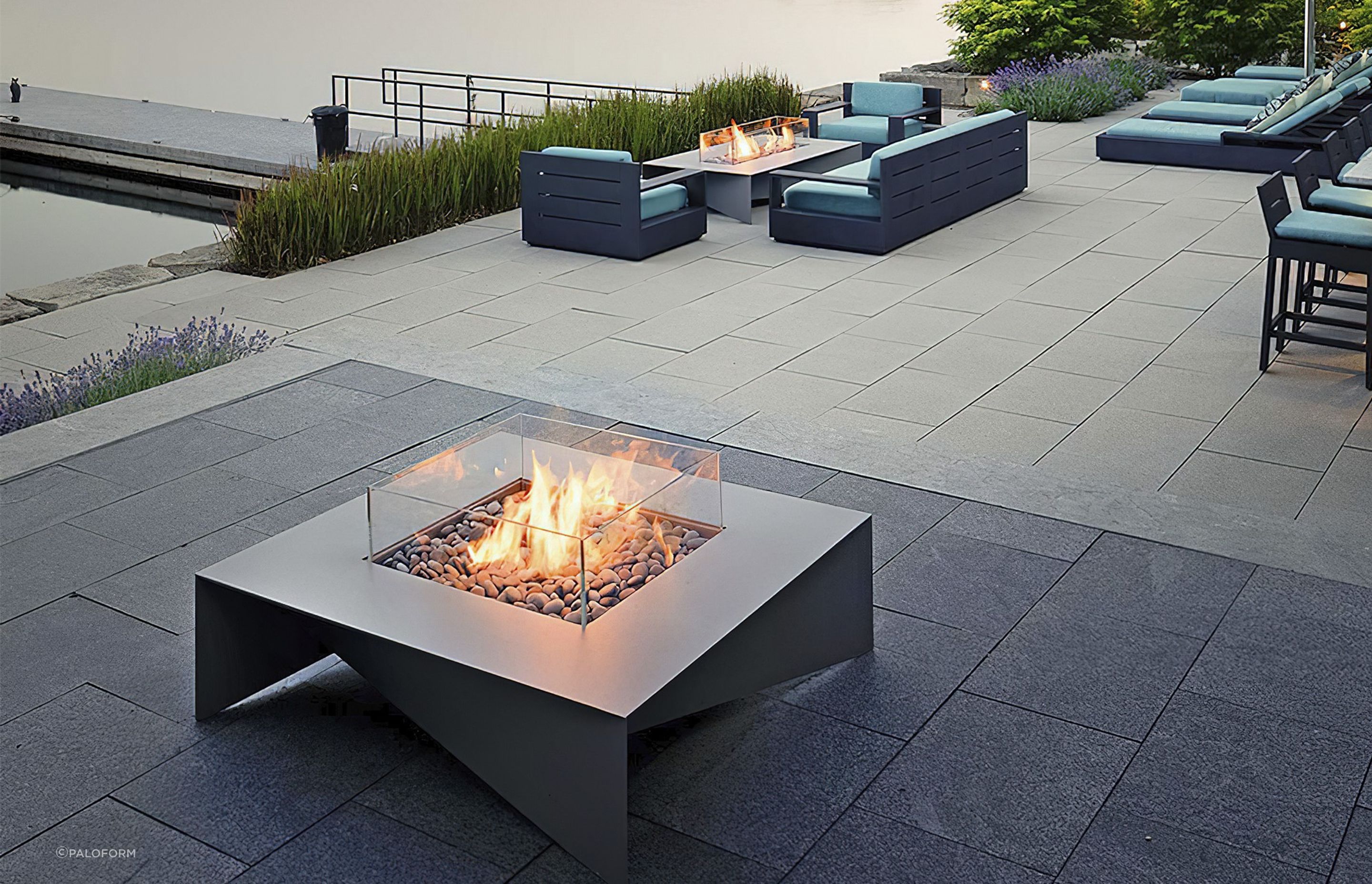 The delicate aluminium planes of the Fold Fire Table touch the ground at each corner in a way that exudes quality