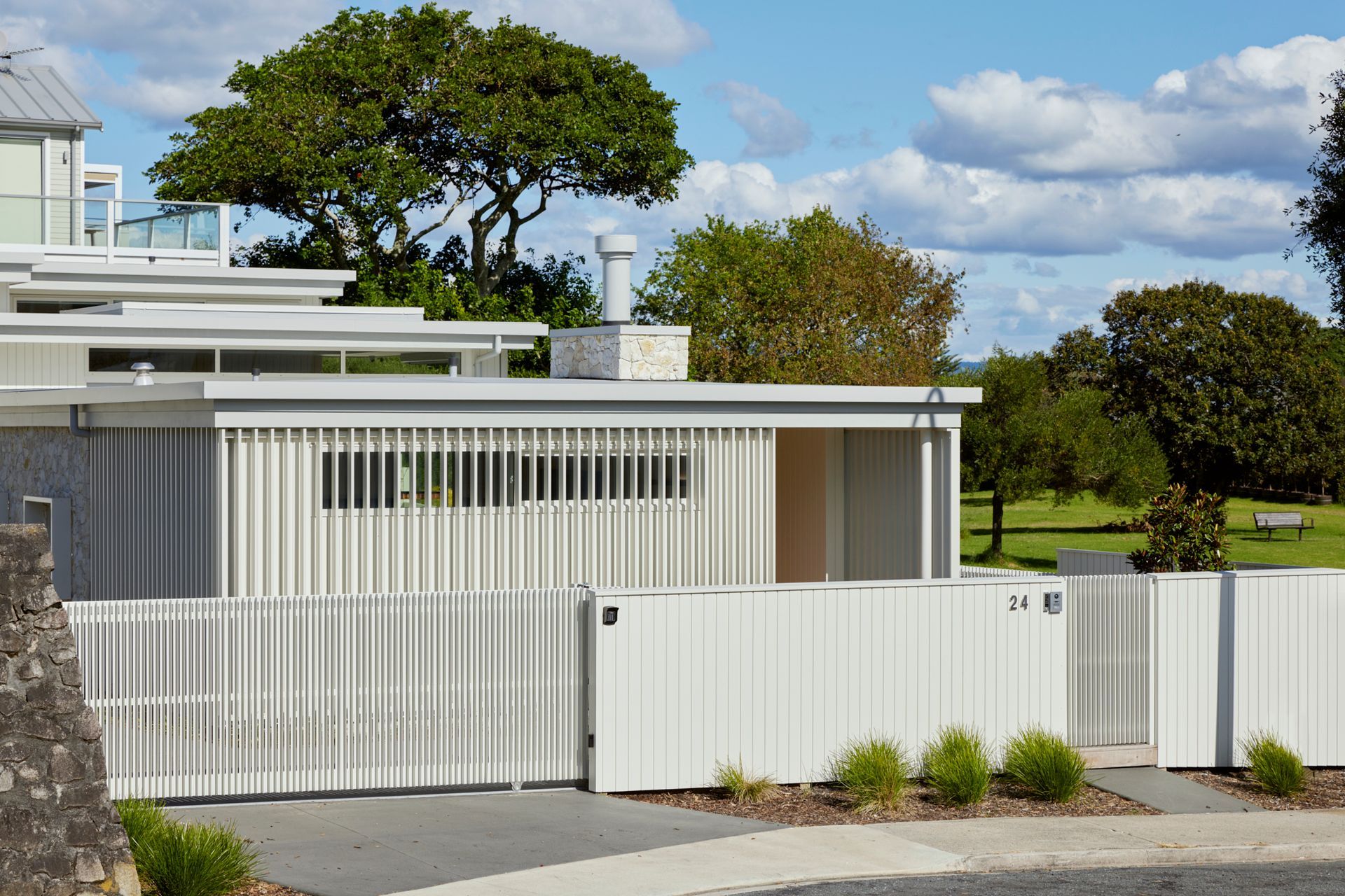 On arrival, crisp white lines and modernist forms meet the street to the north.