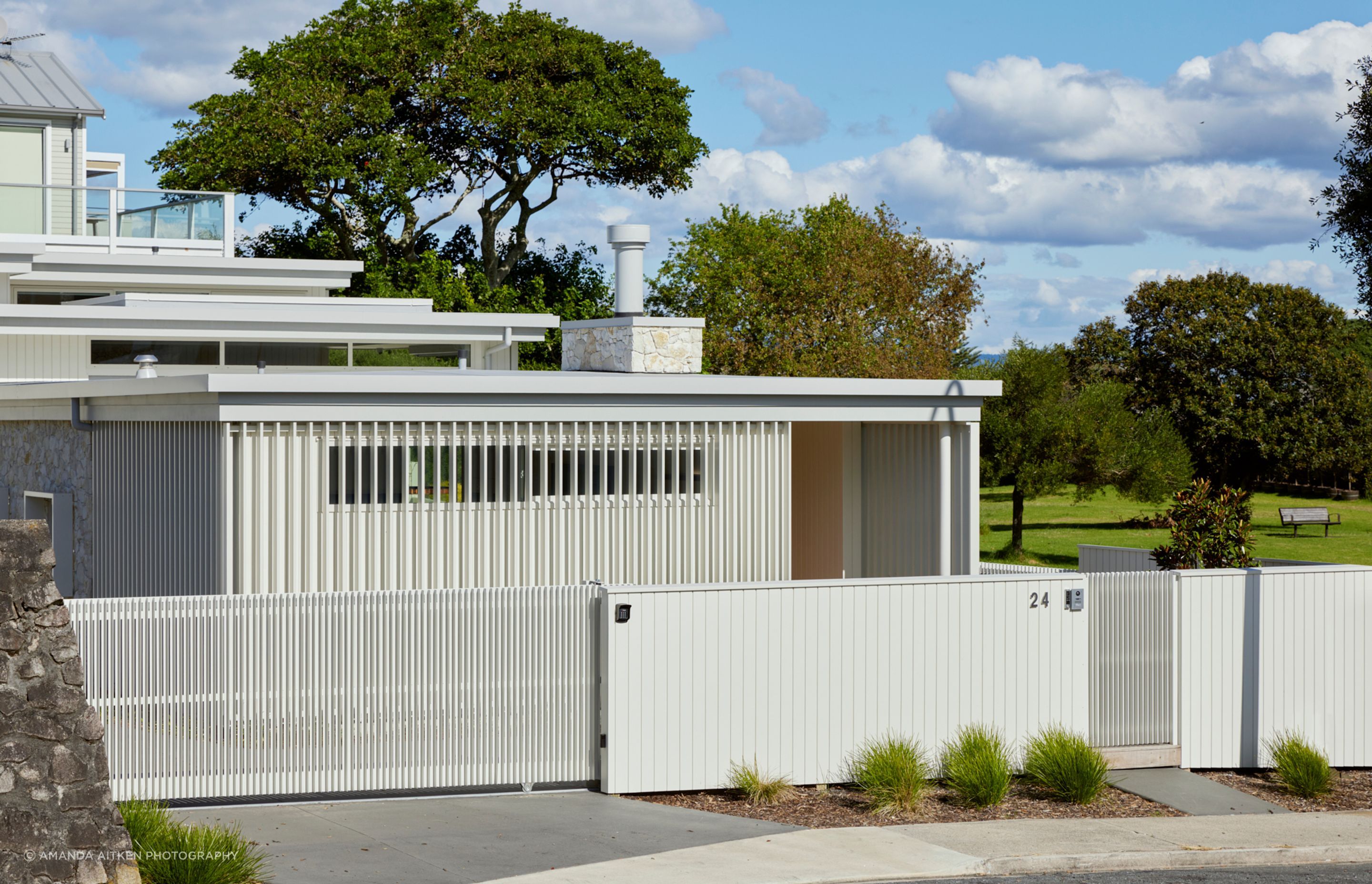 On arrival, crisp white lines and modernist forms meet the street to the north.