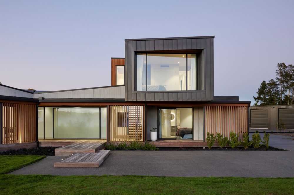 Clad in Eurostyle standing seam iron, the first floor cantilevers over the entrance and guest suite.