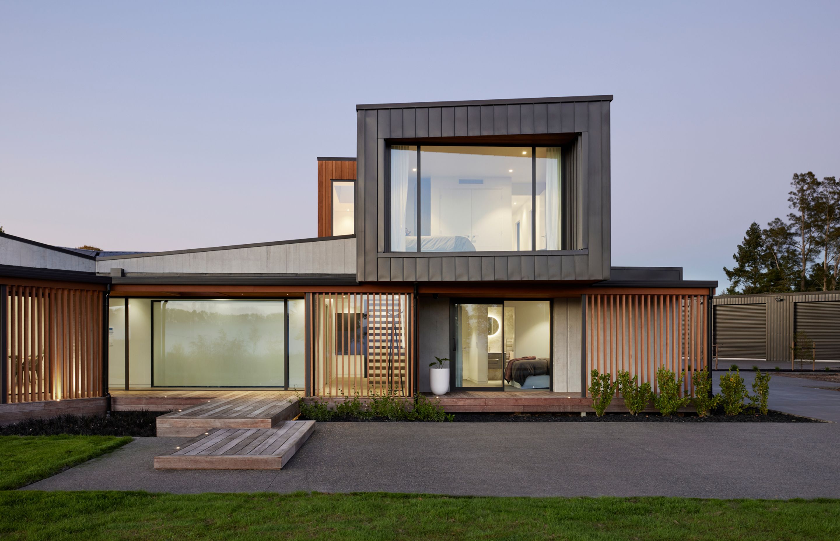 Clad in Eurostyle standing seam iron, the first floor cantilevers over the entrance and guest suite.