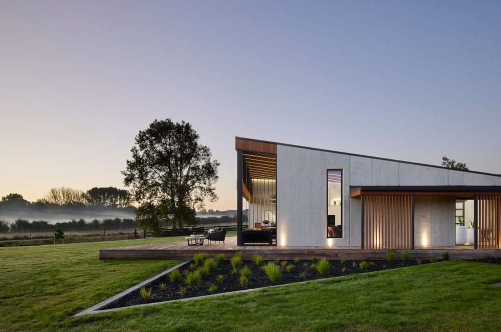 The exterior provides a glimpse as to what to expect inside: natural tones and textures and a soaring ceiling in the living pavilion.