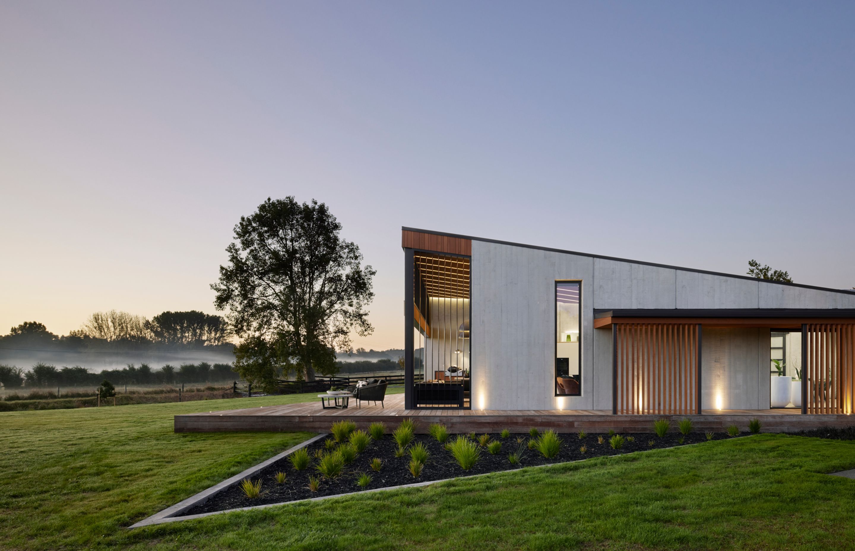 The exterior provides a glimpse as to what to expect inside: natural tones and textures and a soaring ceiling in the living pavilion.