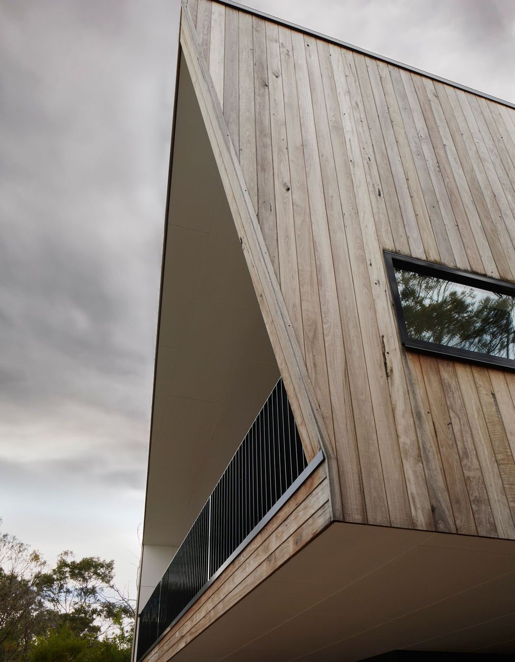 Recycled red ironbark cladding has been left to age naturally and blend with the surrounding environment.
