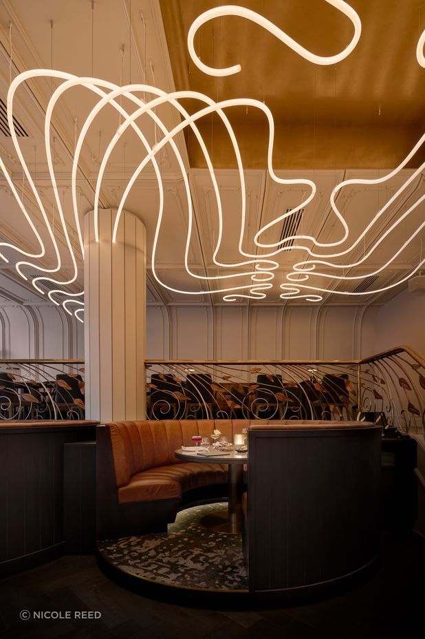 The sculptural chandelier, hand built by Matthew Barter of Major Graphics, has been custom designed to wrap around the columns.