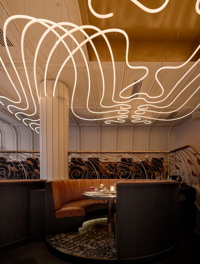 The sculptural chandelier, hand built by Matthew Barter of Major Graphics, has been custom designed to wrap around the columns.