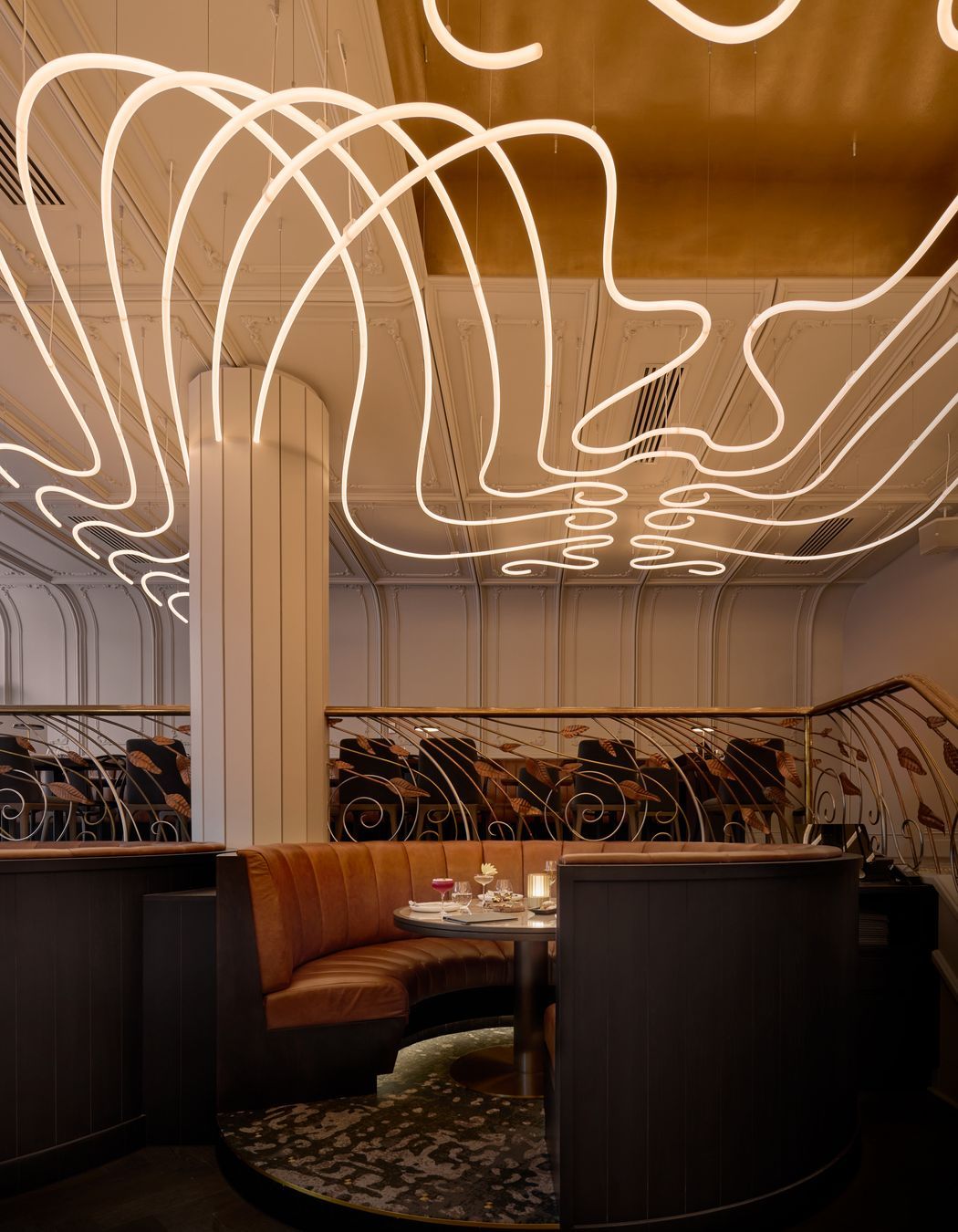 The sculptural chandelier, hand built by Matthew Barter of Major Graphics, has been custom designed to wrap around the columns.