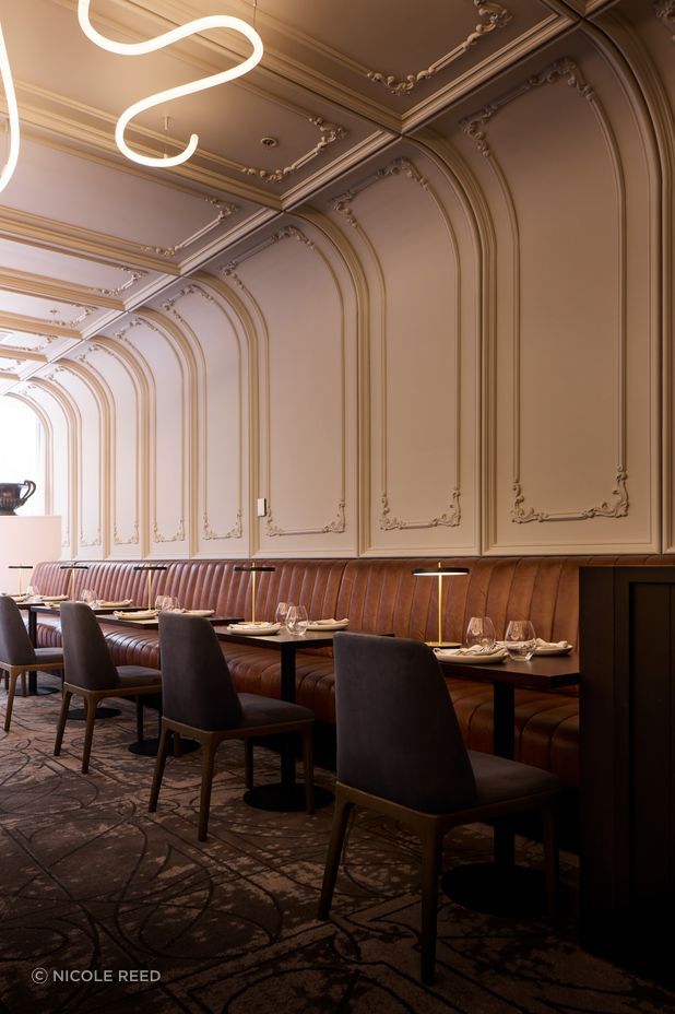 Art Nouveau panelling curves from the wall to the ceiling.