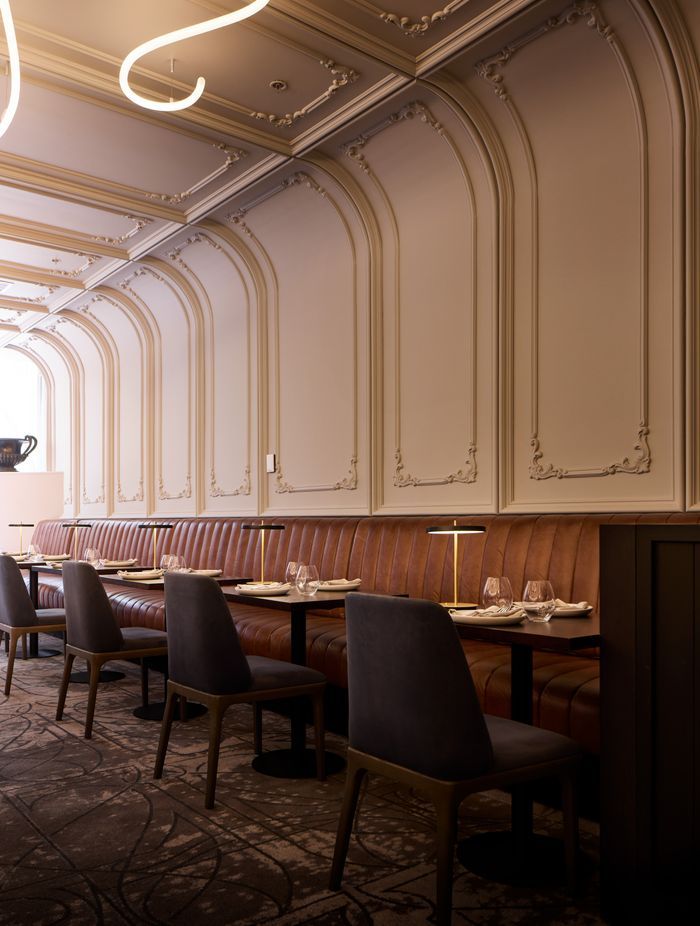 Art Nouveau panelling curves from the wall to the ceiling.