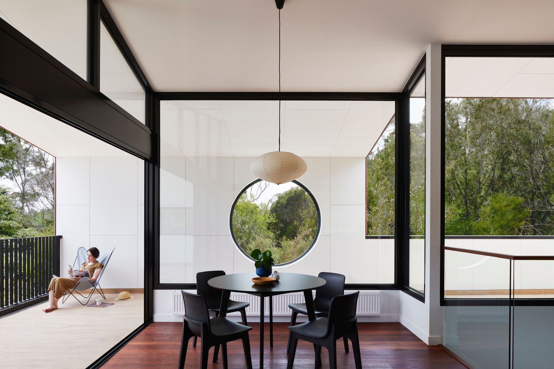 The view captured in the round window can be enjoyed from the dining area.