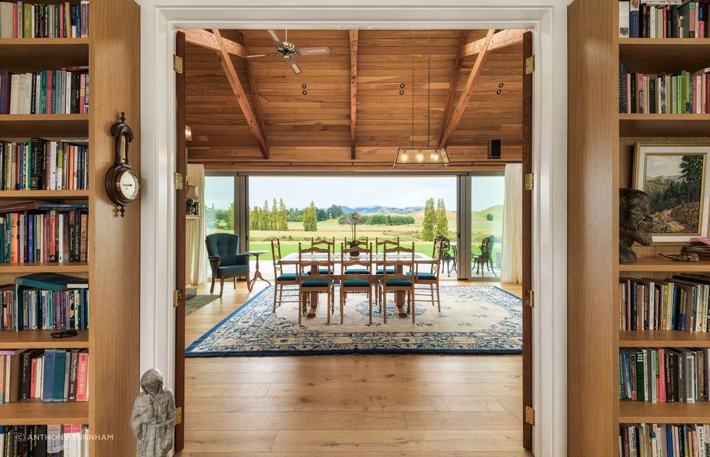 The view across the dining table. The flooring is by Forté Flooring and the ceiling is macrocarpa.